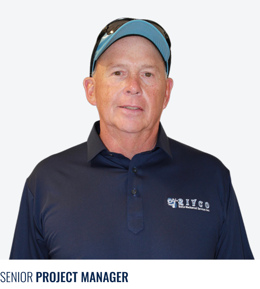 A middle-aged man with fair skin, short red hair, wearing a black button-up shirt with a company logo, a light blue cap, and sunglasses on his head.