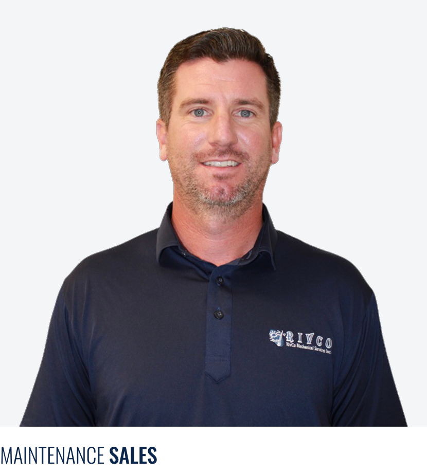 A man with short brown hair and a beard, wearing a navy blue polo shirt with a company logo, smiling against a plain background.
