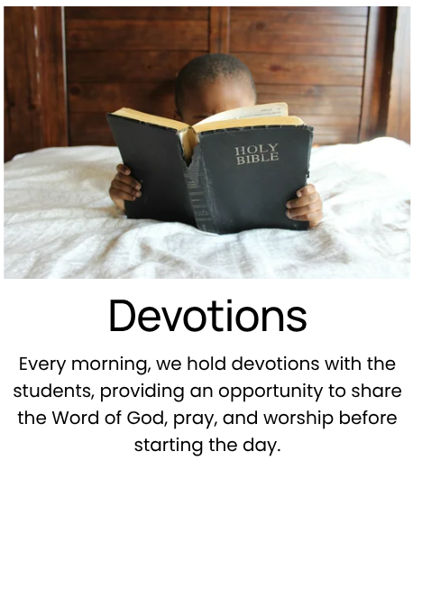 A young child reading the Bible while sitting on a bed, with a wooden headboard in the background.