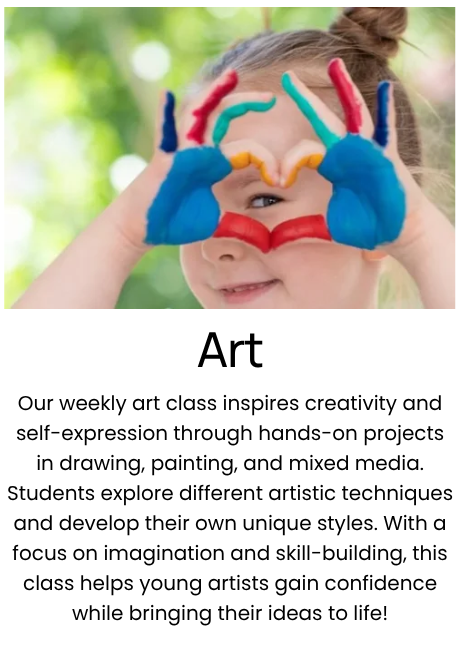 A young girl is smiling and holding her hands up to her face, forming colorful hearts and shapes with her fingers and painted hands, with a blurred green outdoor background.