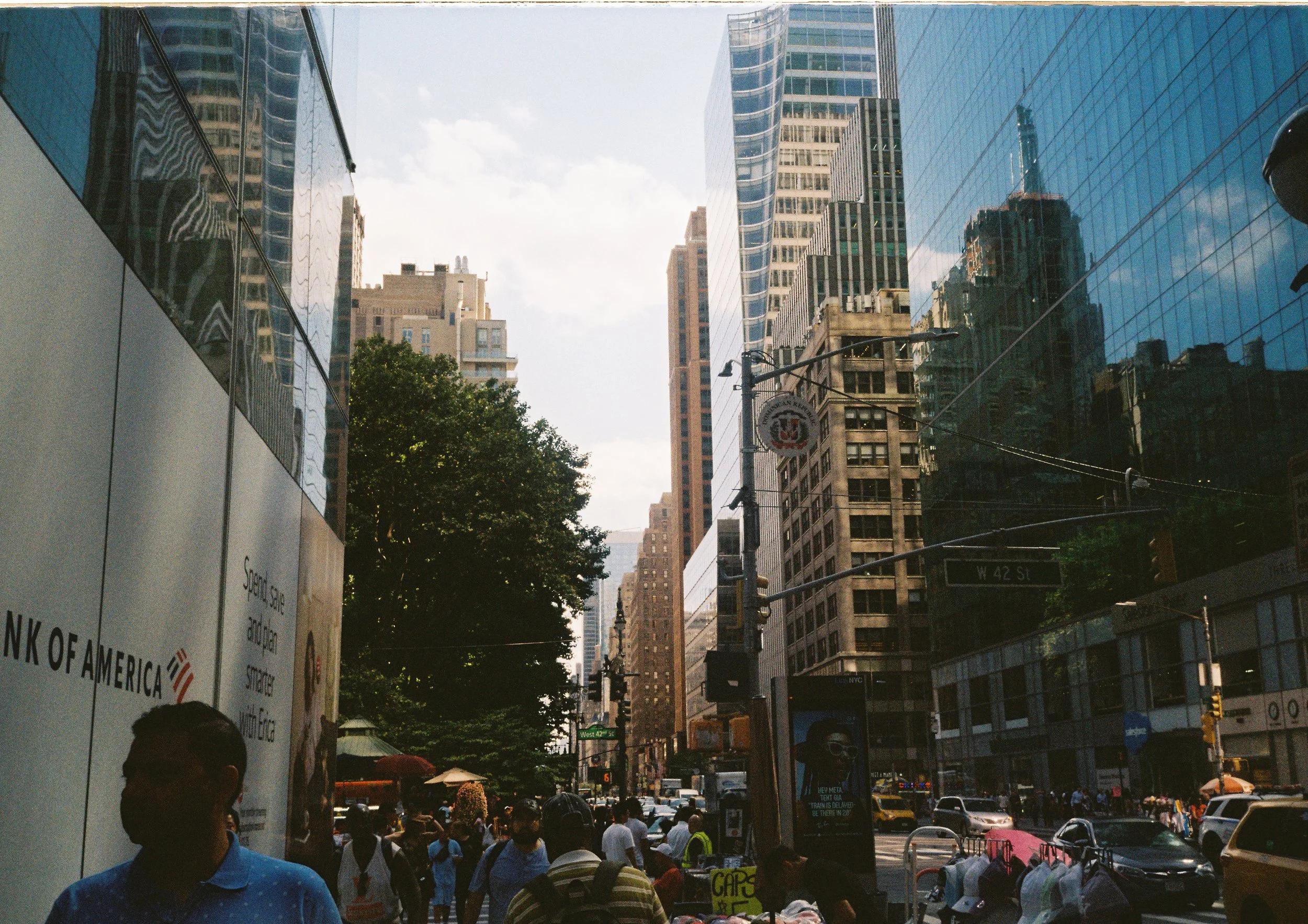 Street view of pedestrians and reflective city buildings
