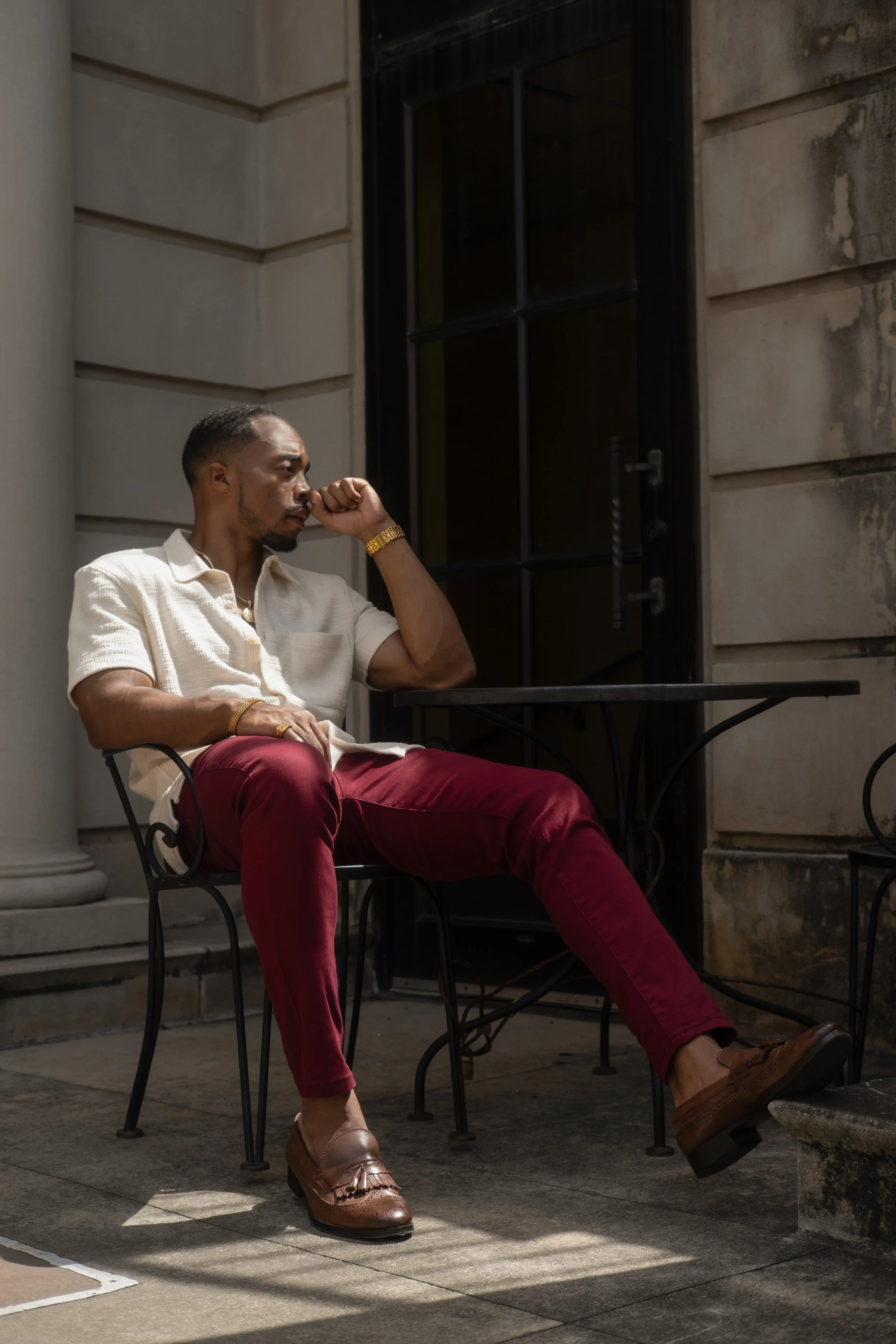 Full-body framing of Corey sitting