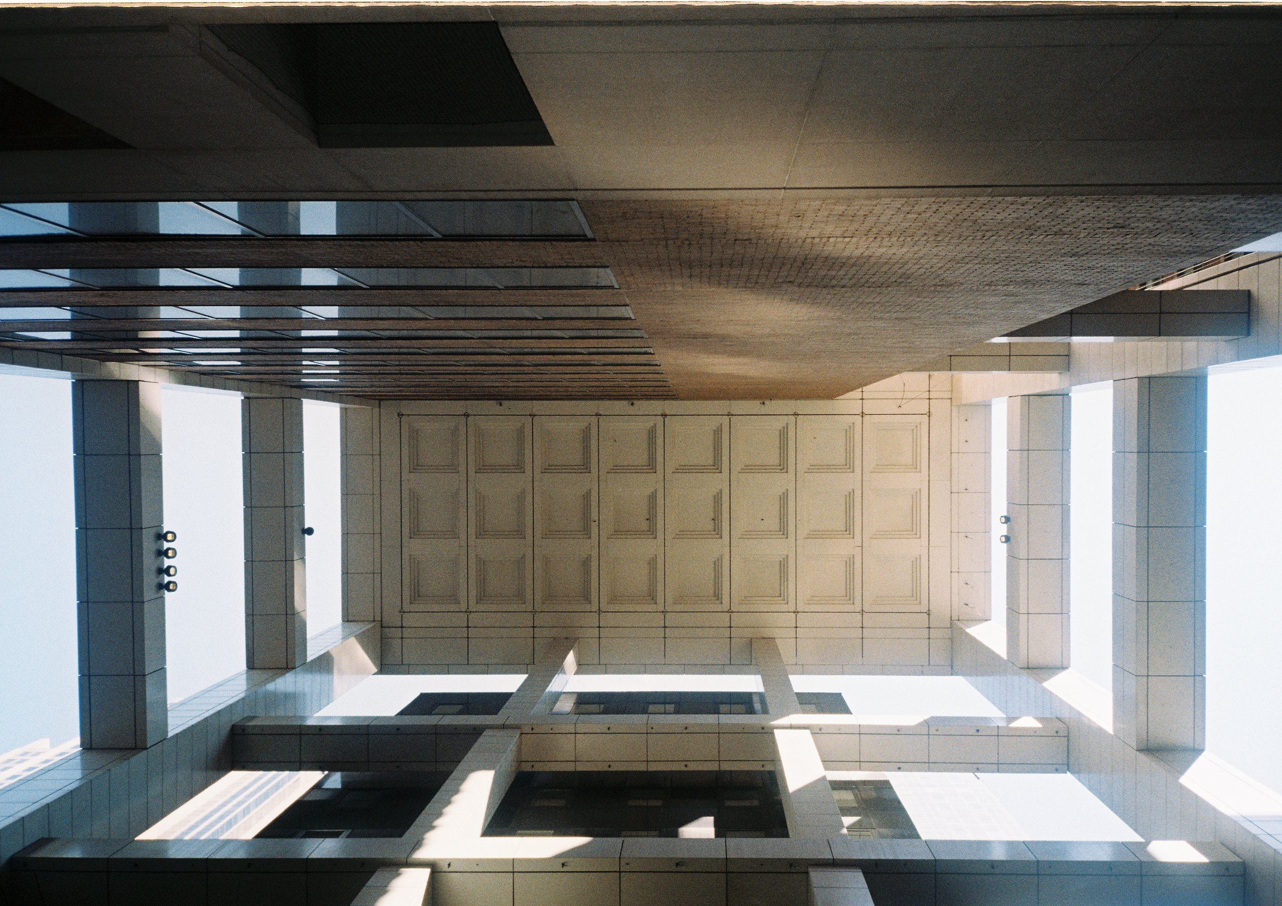 Ground-up view of awning between tall city buildings