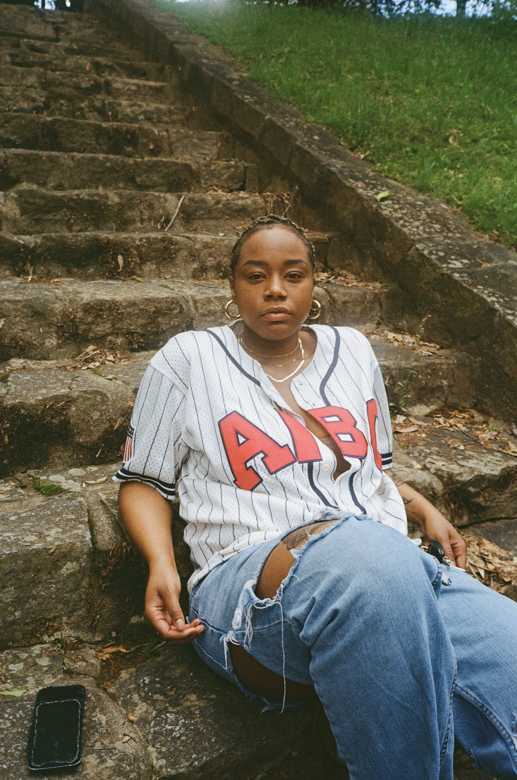 Taylor leaning against stone stairs
