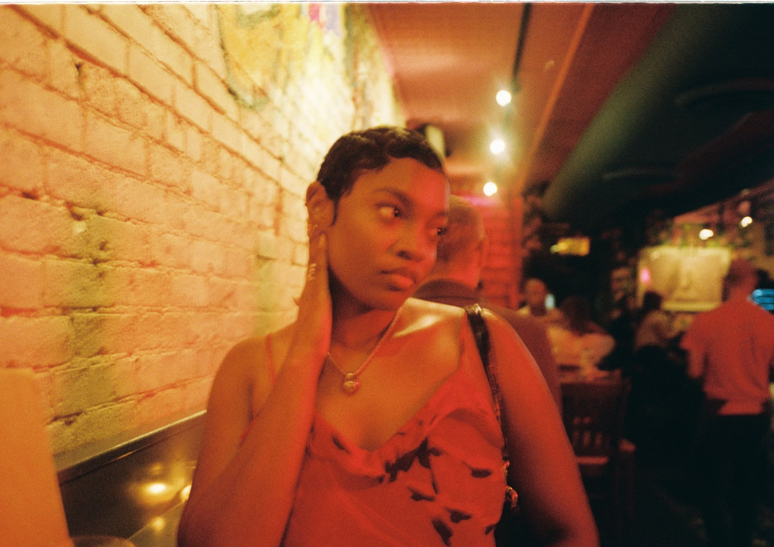 Half-body framing of Noelle in restaurant