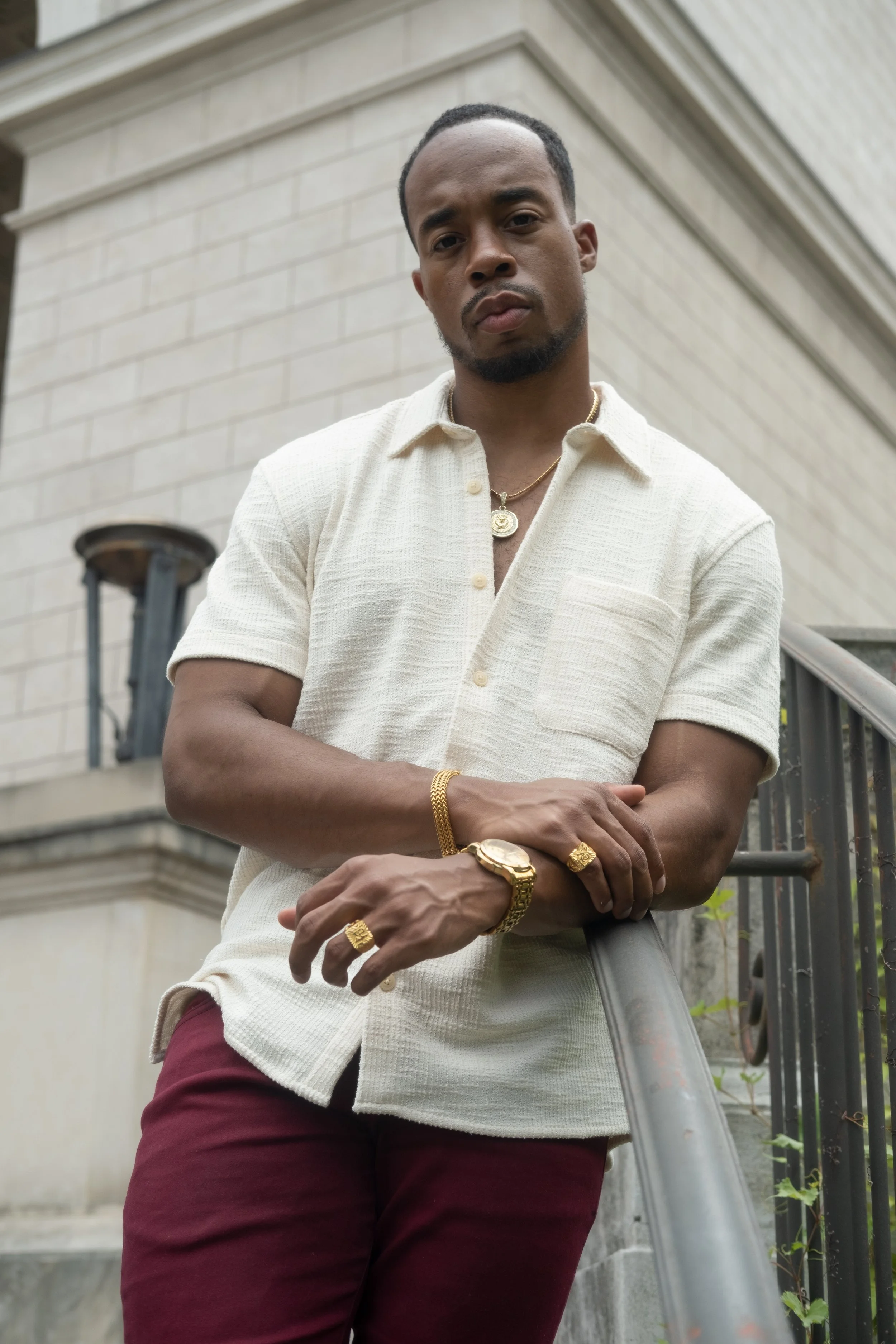 Half-body framing of Corey leaning on railing