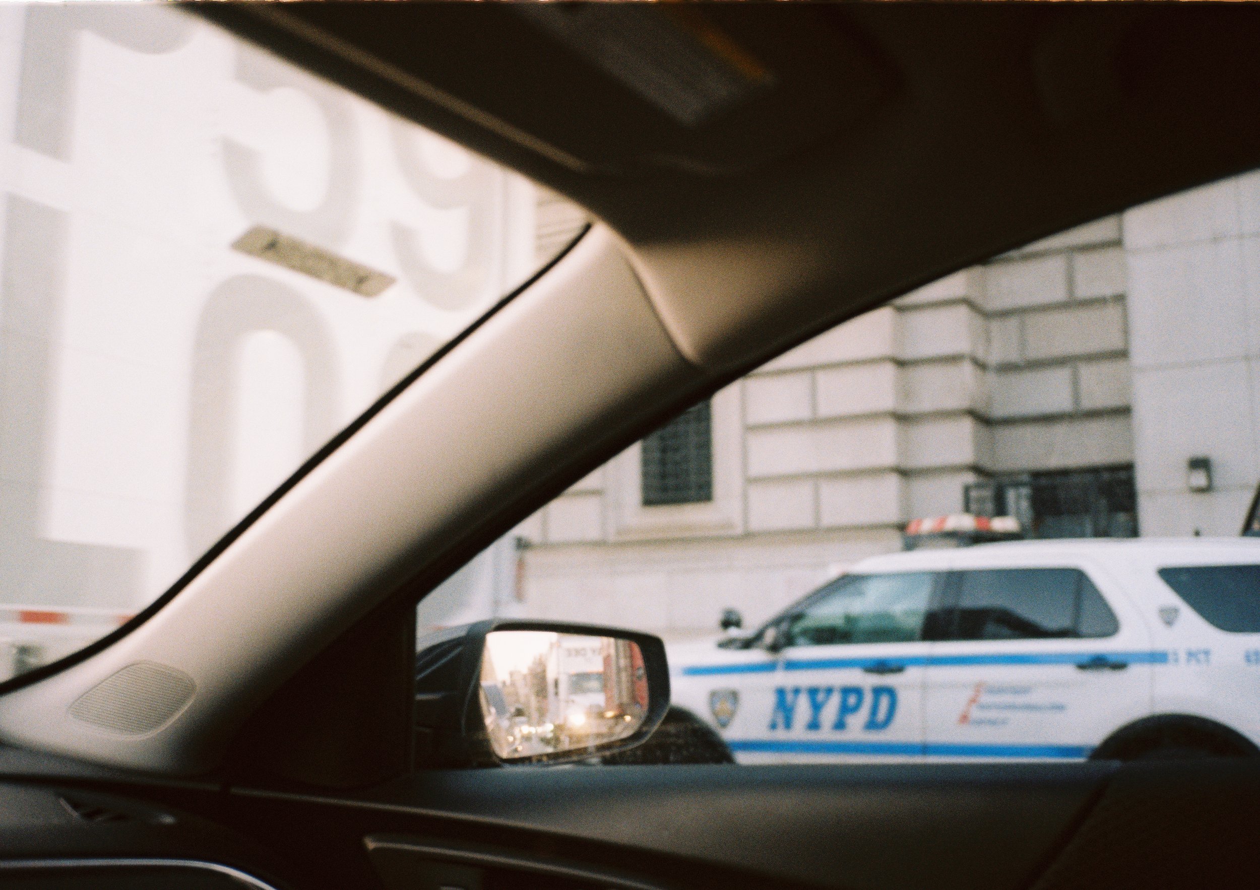 Car window view of cop car on street