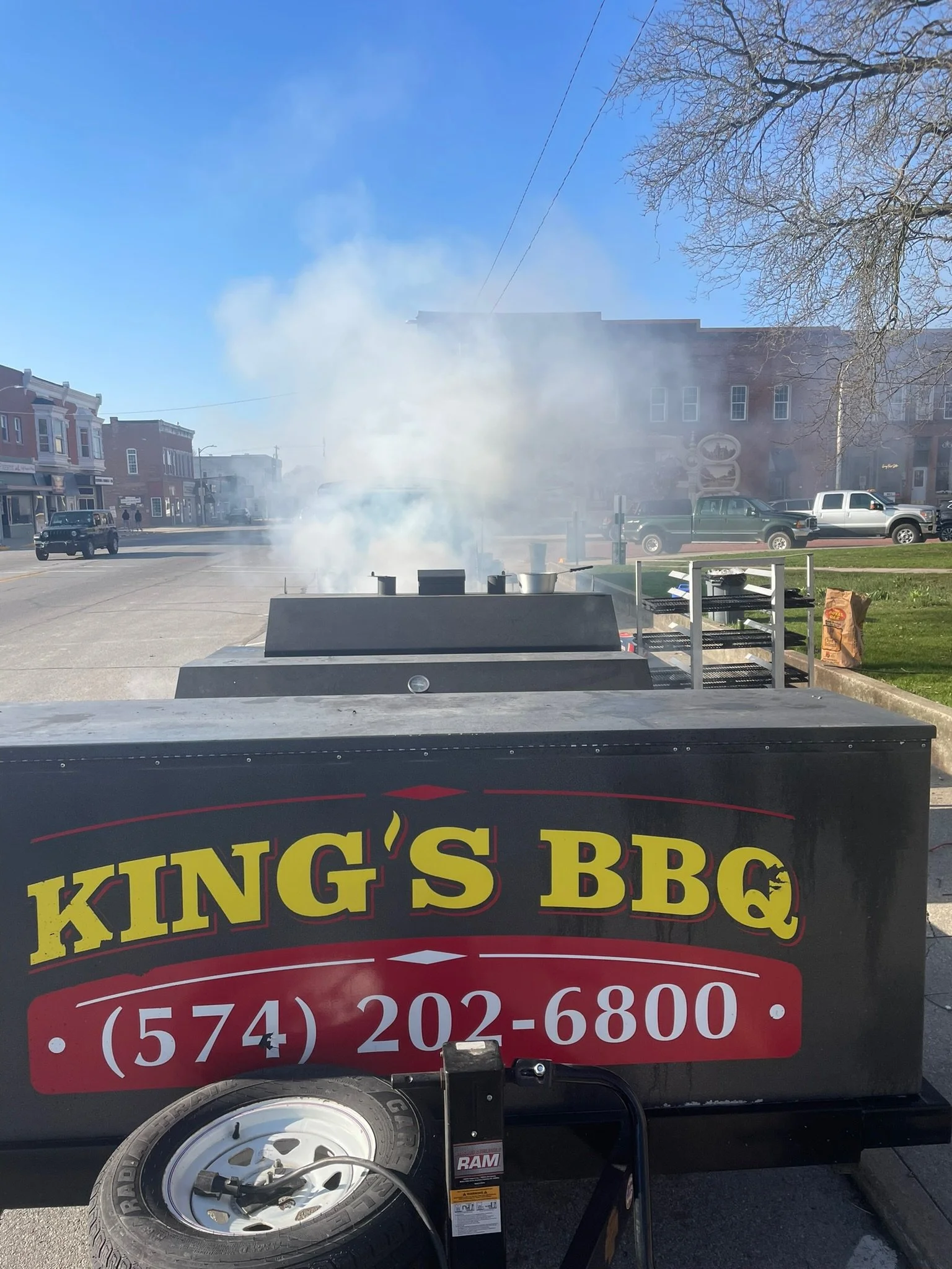 A barbecue smoker trailer from King's BBQ catering setup in Goshen, Indiana