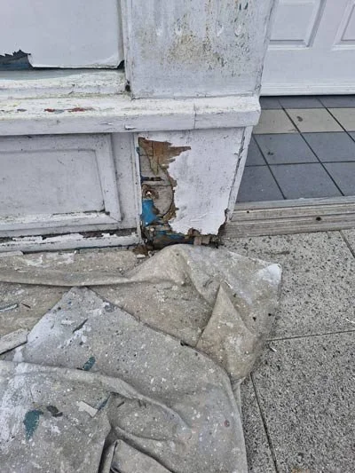 damaged woodwork on exterior of shop