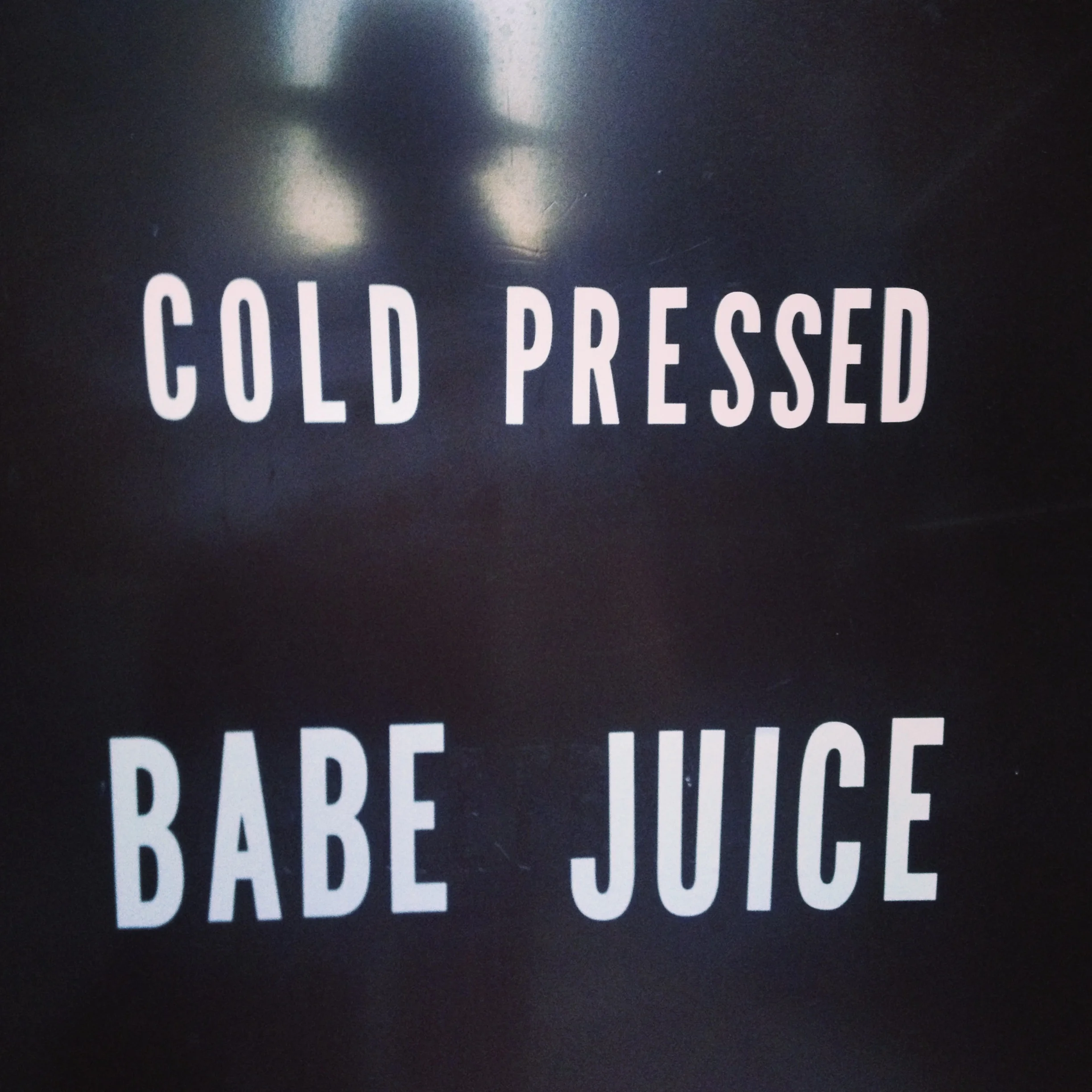 Black background with white text that reads 'Cold Pressed Babe Juice'.