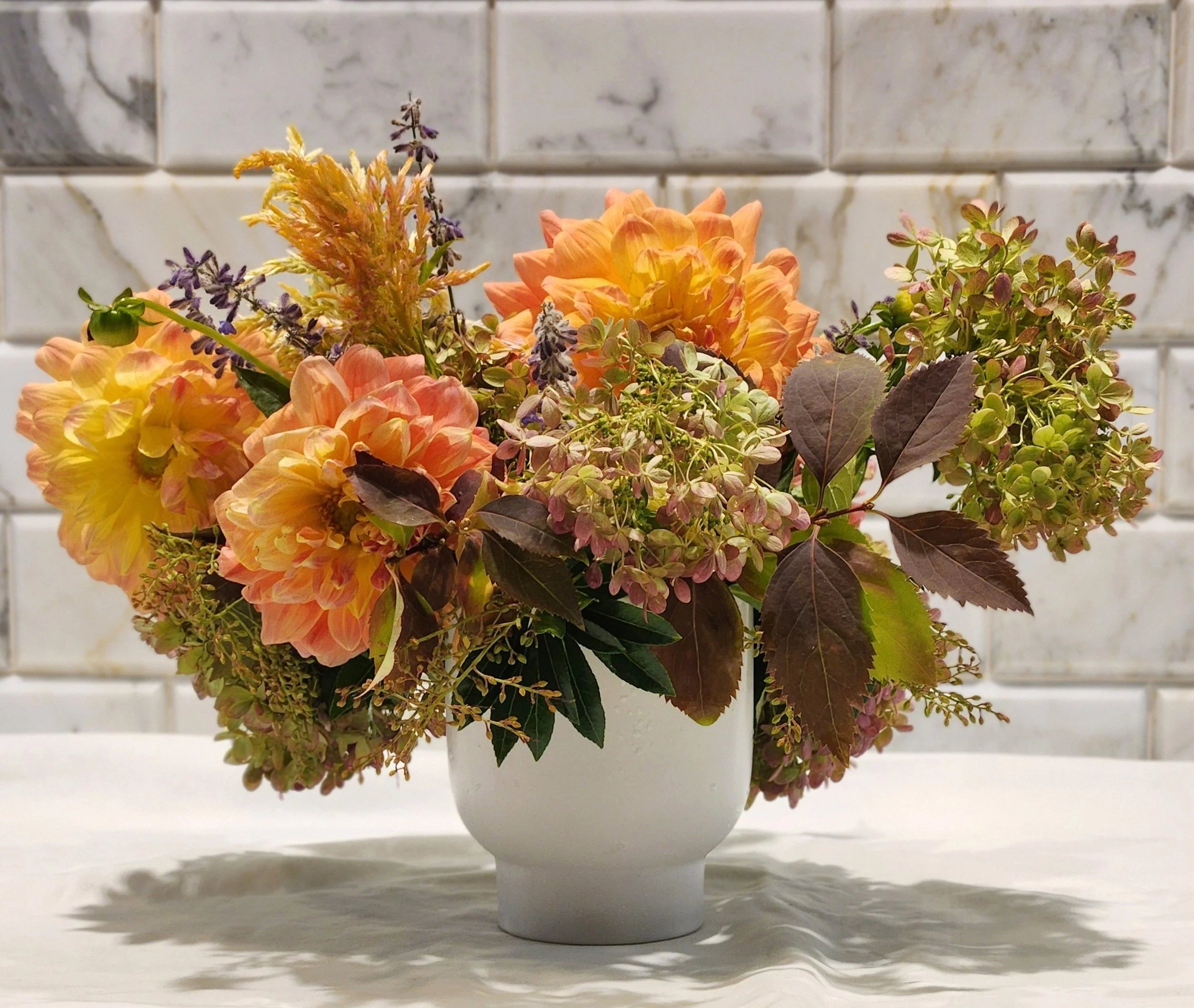 Sunset rehearsal dinner florals, tangerine dahlias