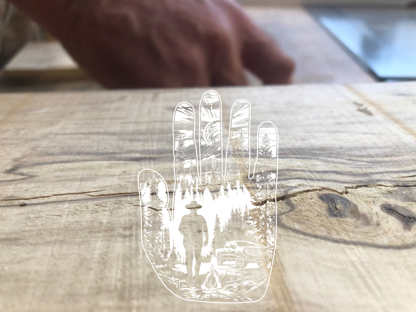A large rough cut slab or wood is being planed by a male carpenter's hands in a depth of field background. Overlaid the wooden arches is the logo watermarked slightly transparent in white.
