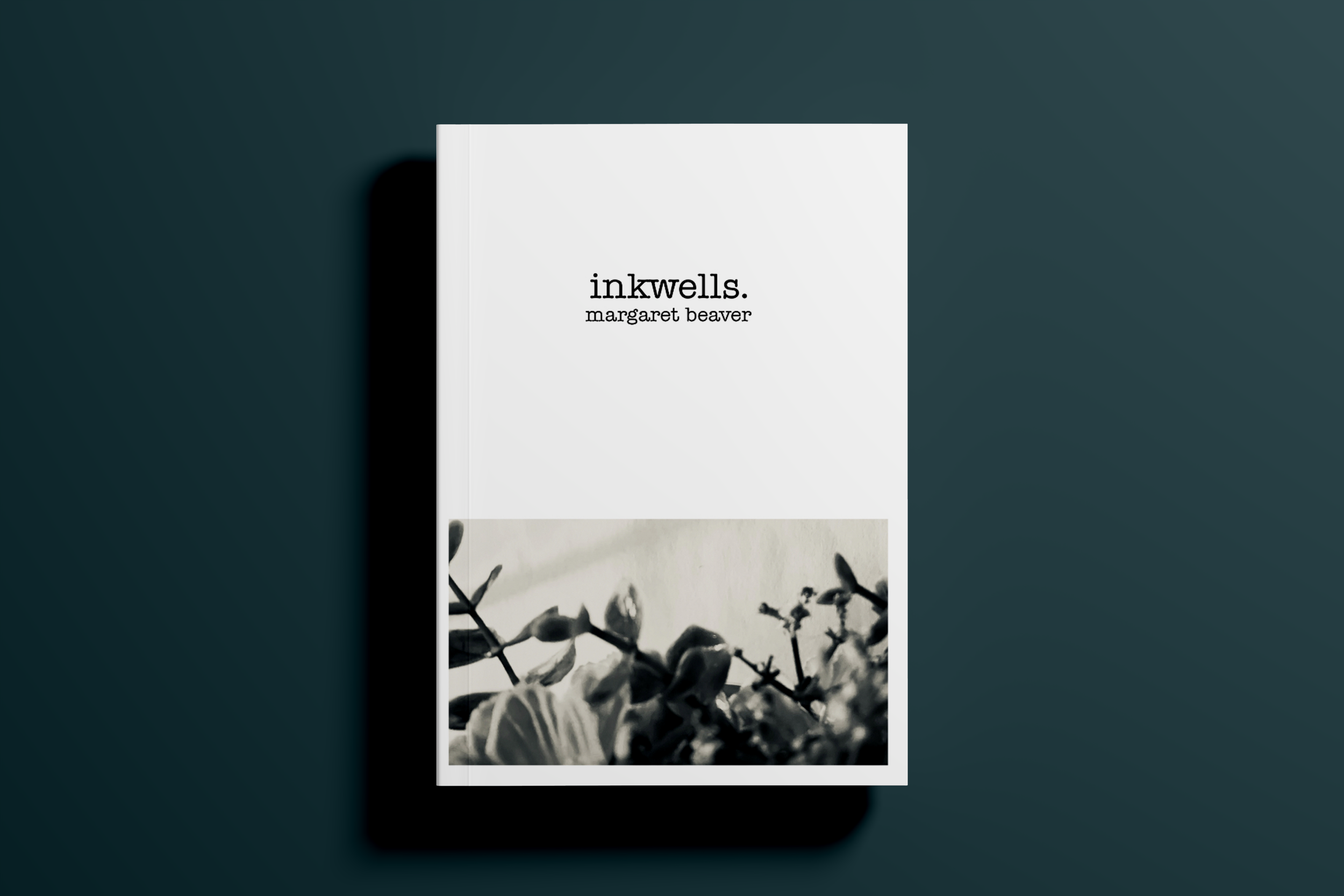 A book titled 'inkwells.' by Margaret Beaver placed on a dark surface with a shadow cast to the left.
