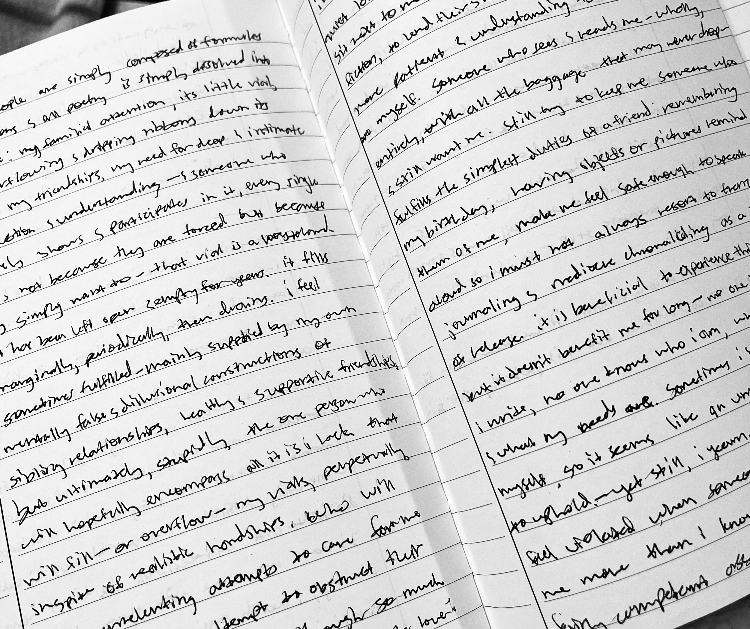 A handwritten journal open to two pages filled with cursive writing.