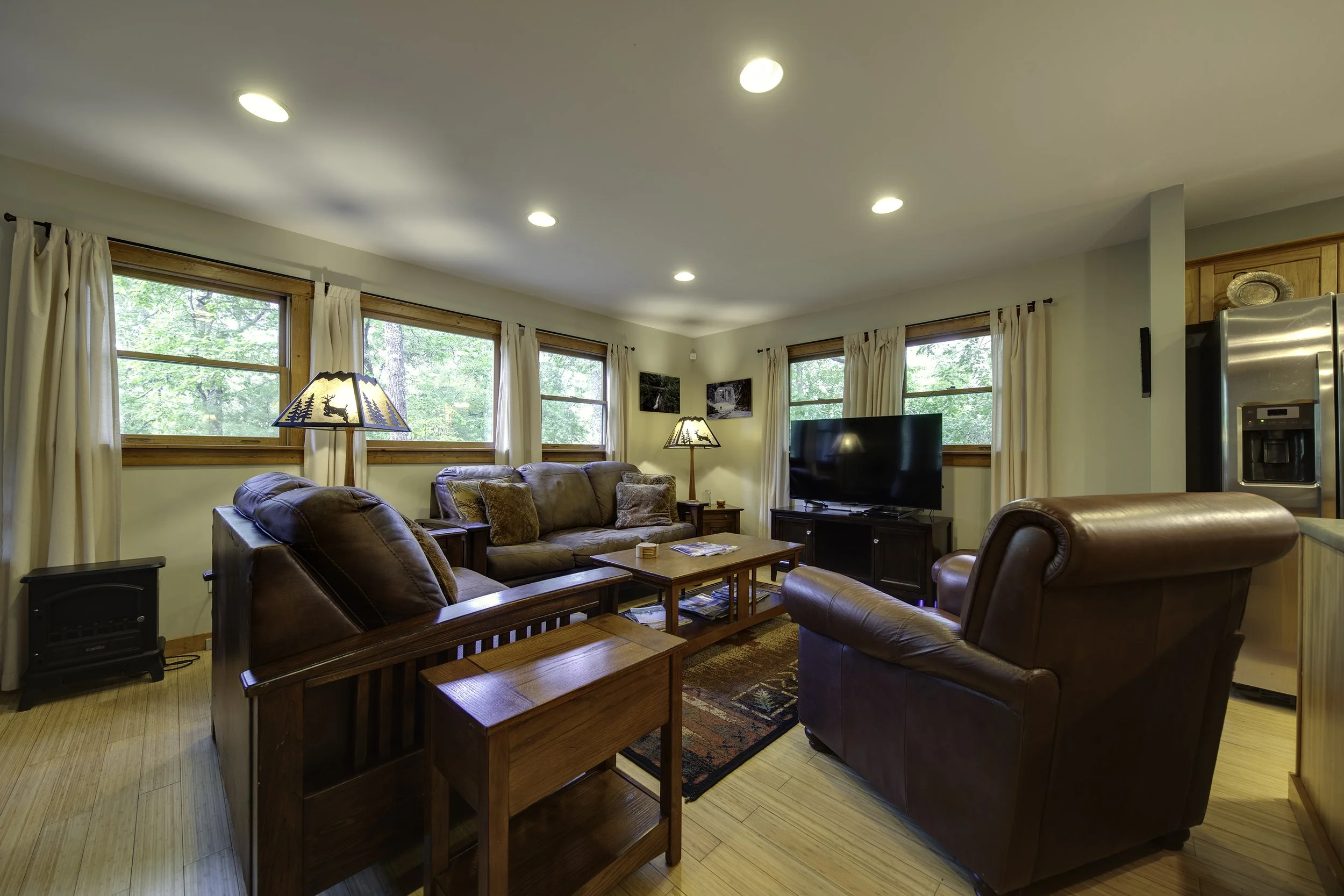 Cabin has a very comfortable living area with large comfy sofa, love seat and chair. Smart TV and DVD player faces sitting area.