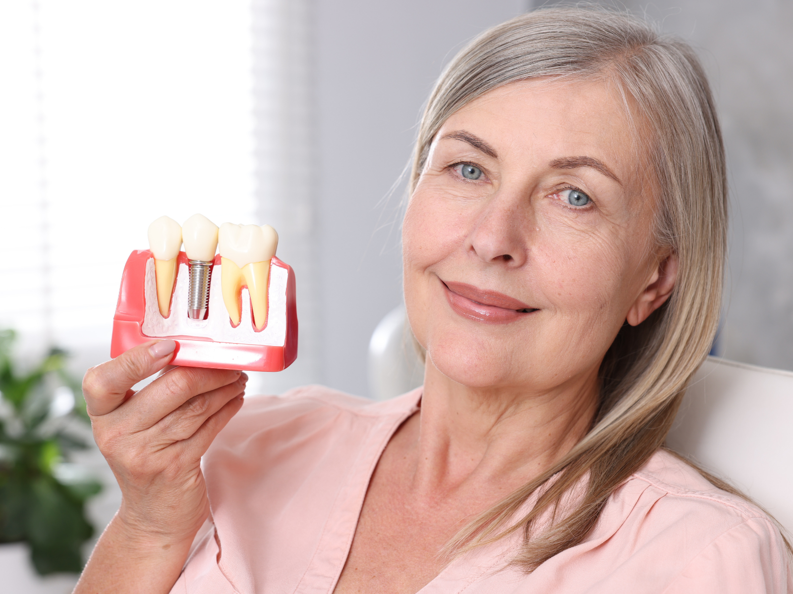 woman holding tooth model