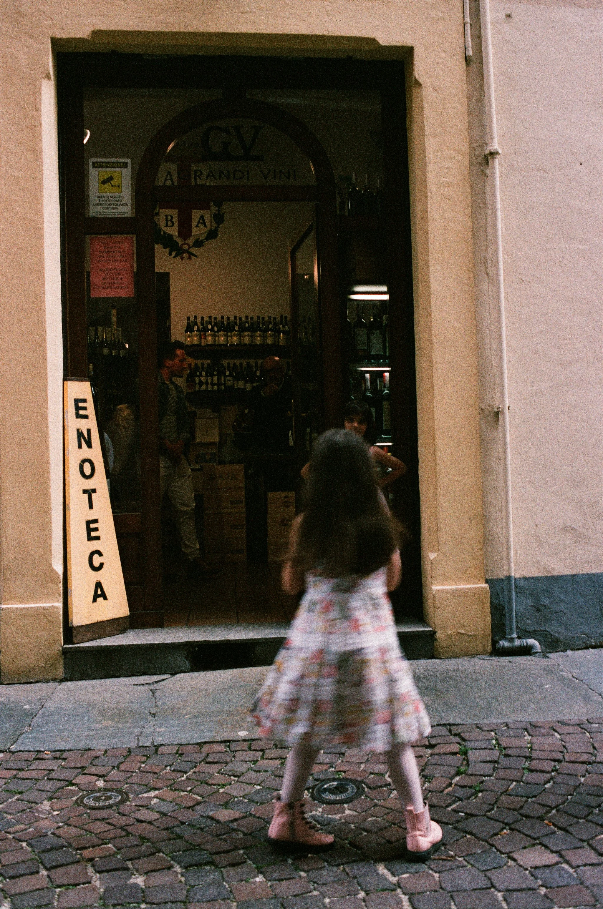 Girl walks into Enoteca with natural light