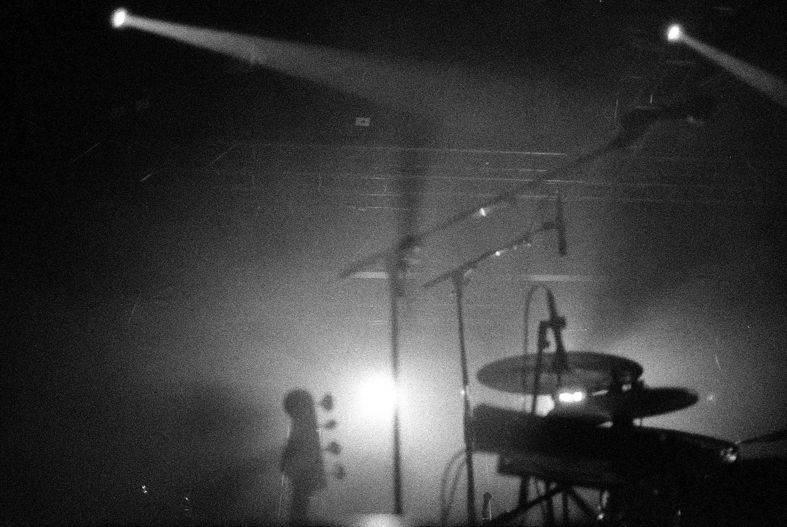 Stage with cymbals and haze during pre-show lighting.