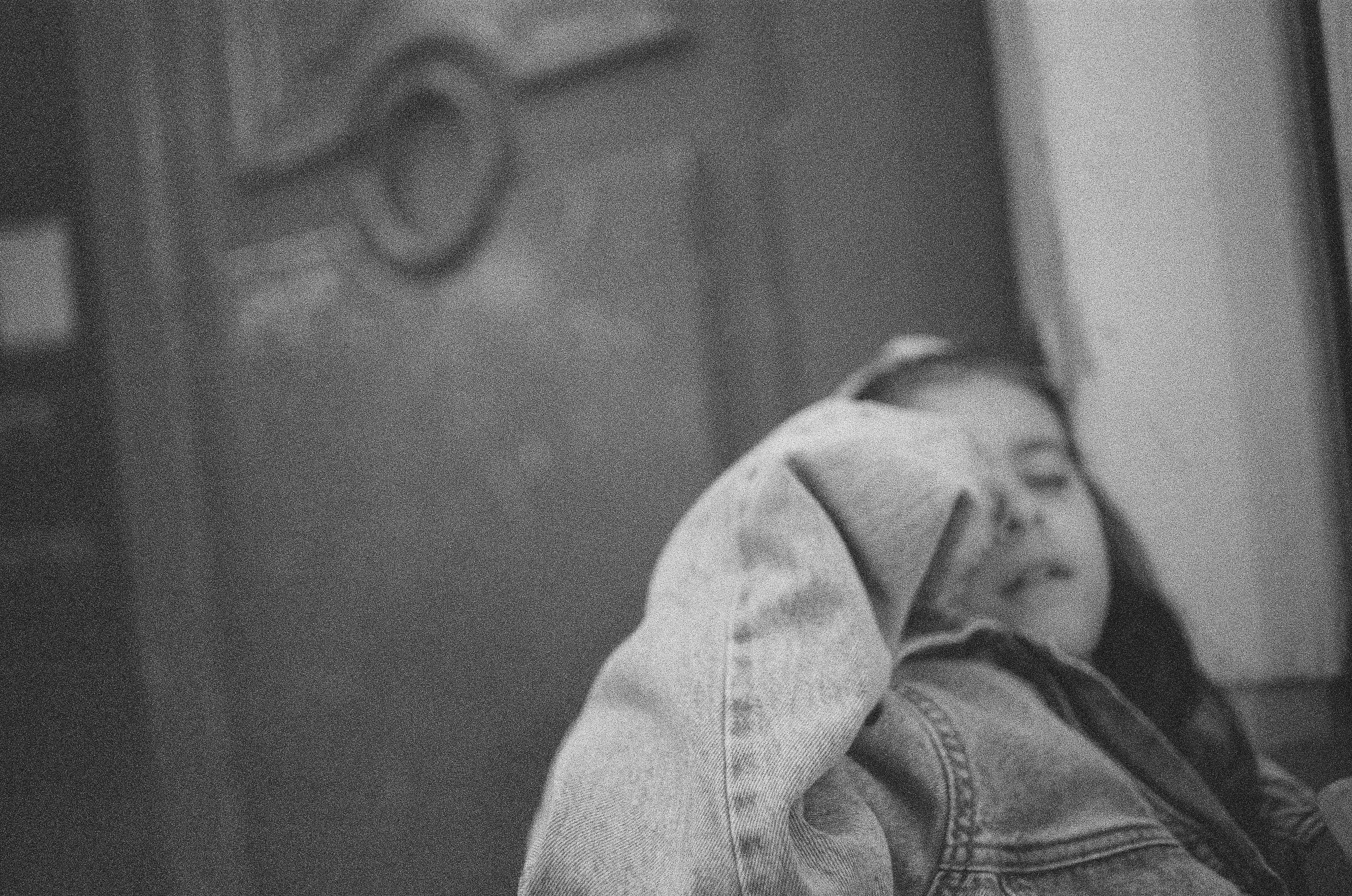 Figure reclining outdoors, partially obscured