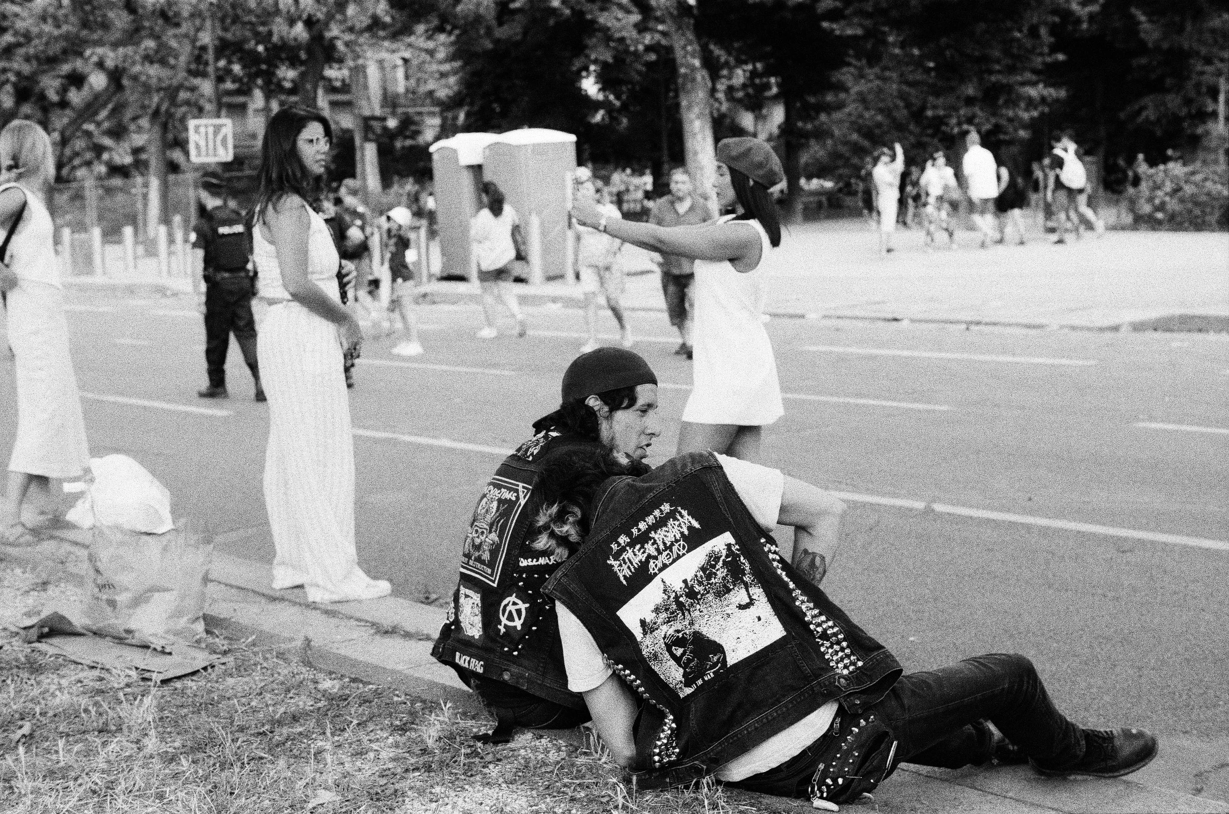 Punks sit in front of Effiel Tower in Paris, analogue photograph.