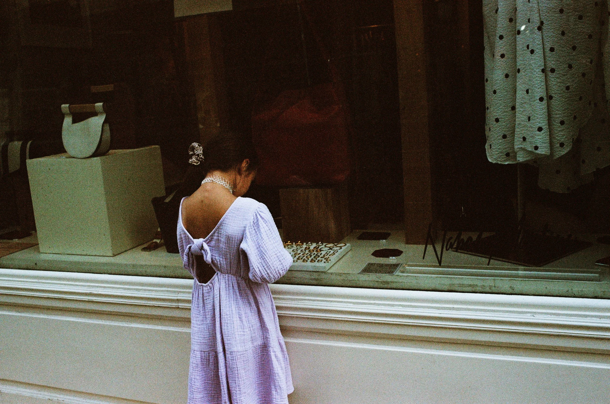 Girl admire shop window, analogue photograph