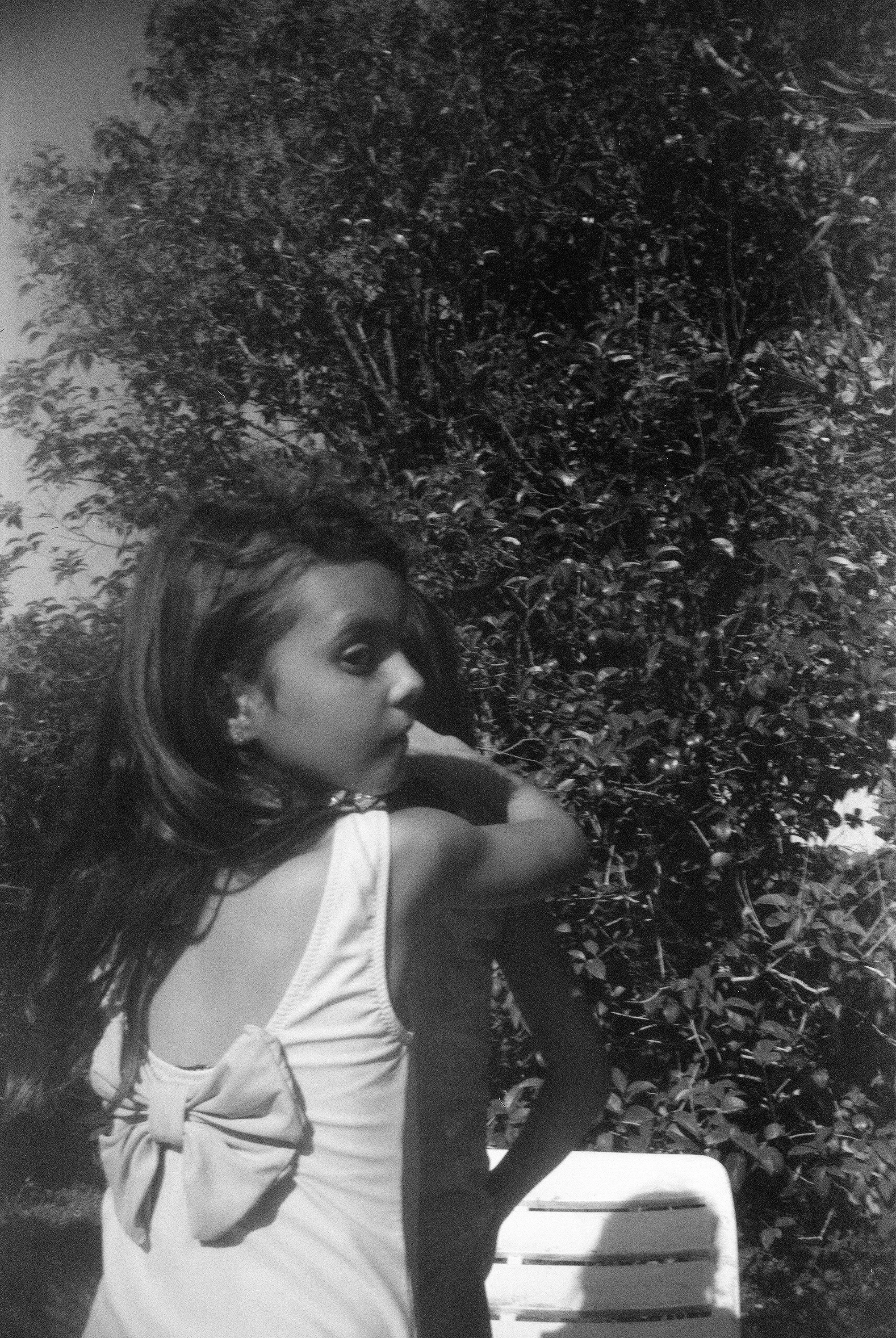 Girl in bathing suit looks back, analogue photograph