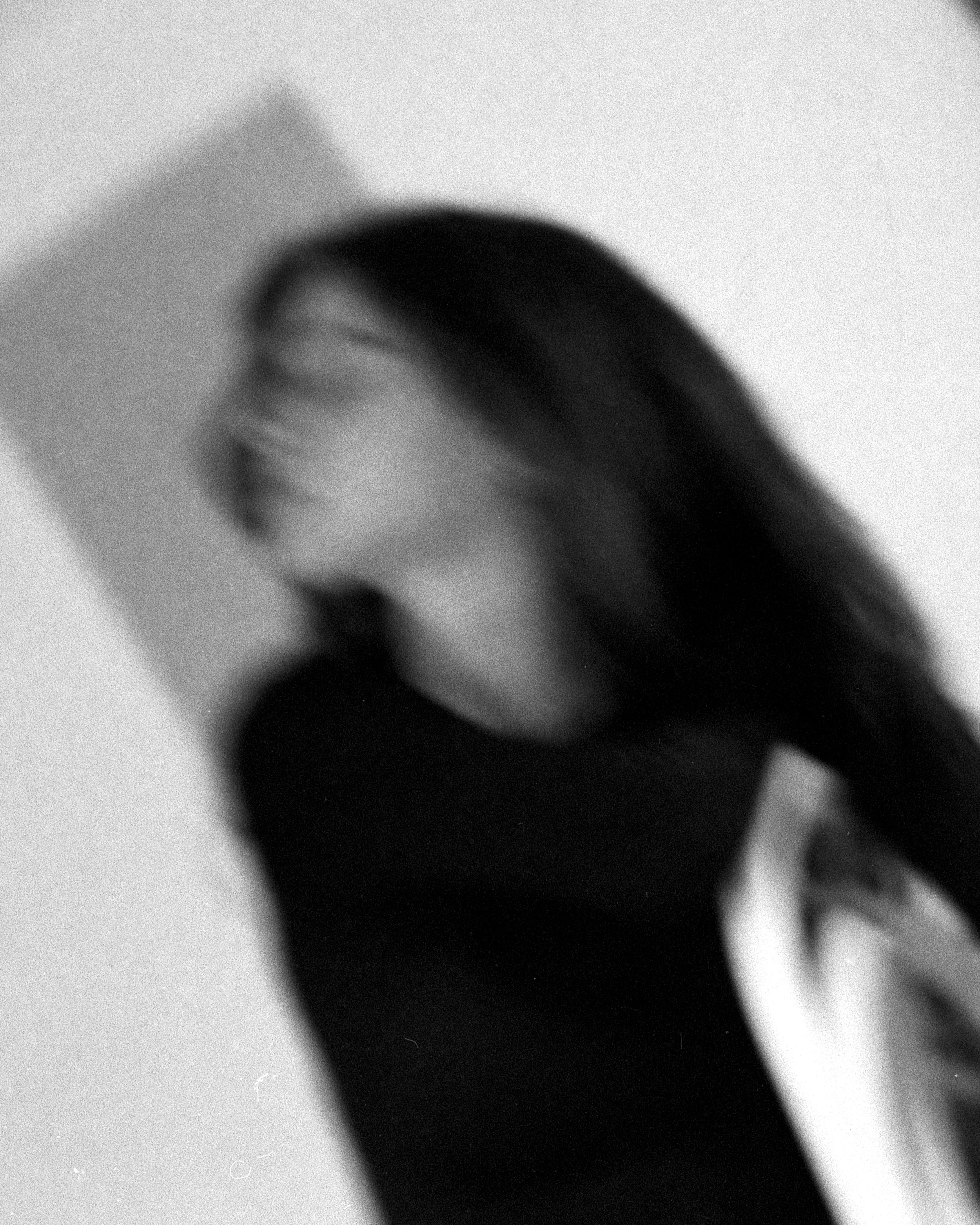 Young woman sitting in a chair - black & white analog photography
