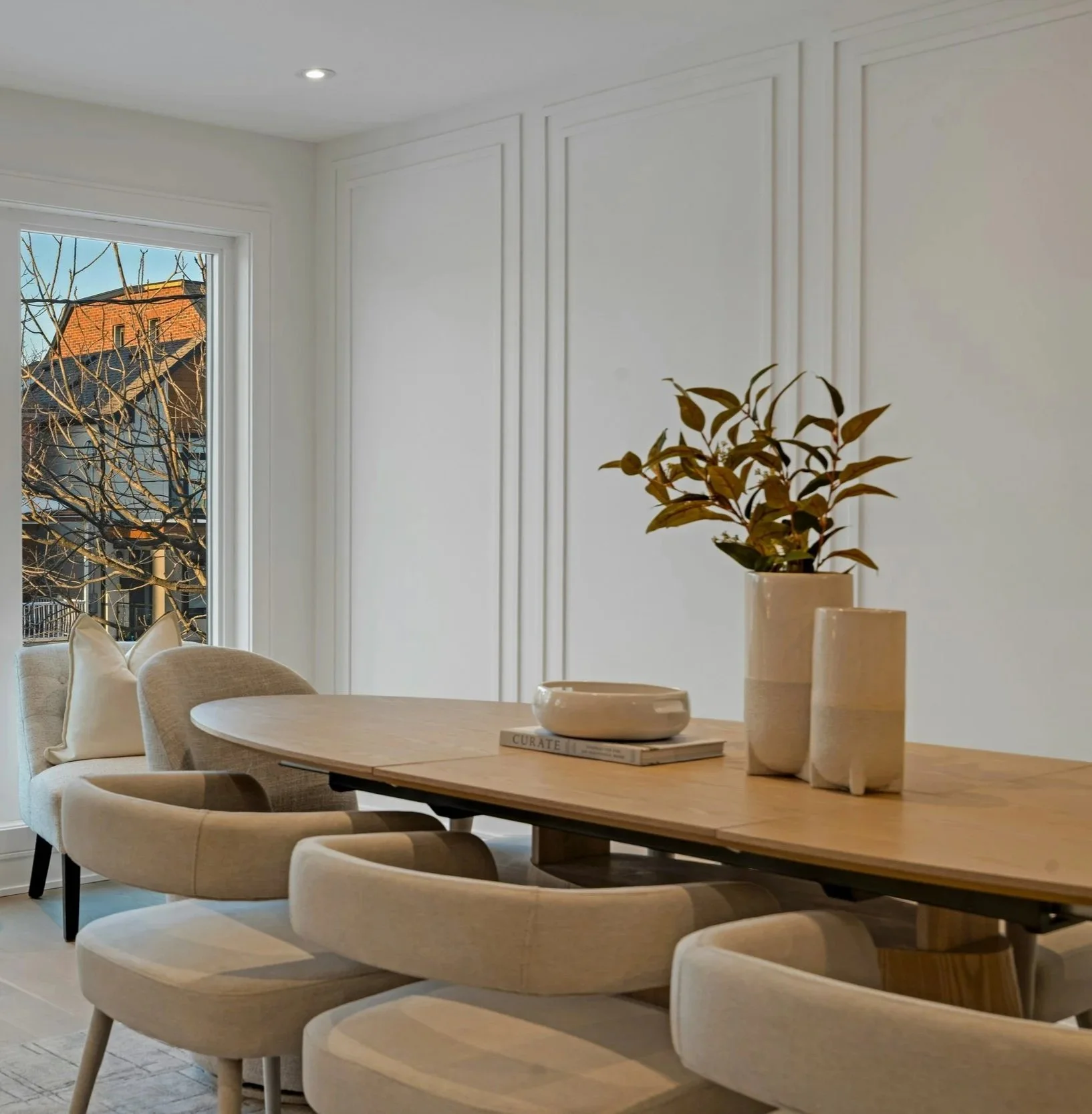 Decorative wall paneling adding texture and dimension to a neutral dining room interior