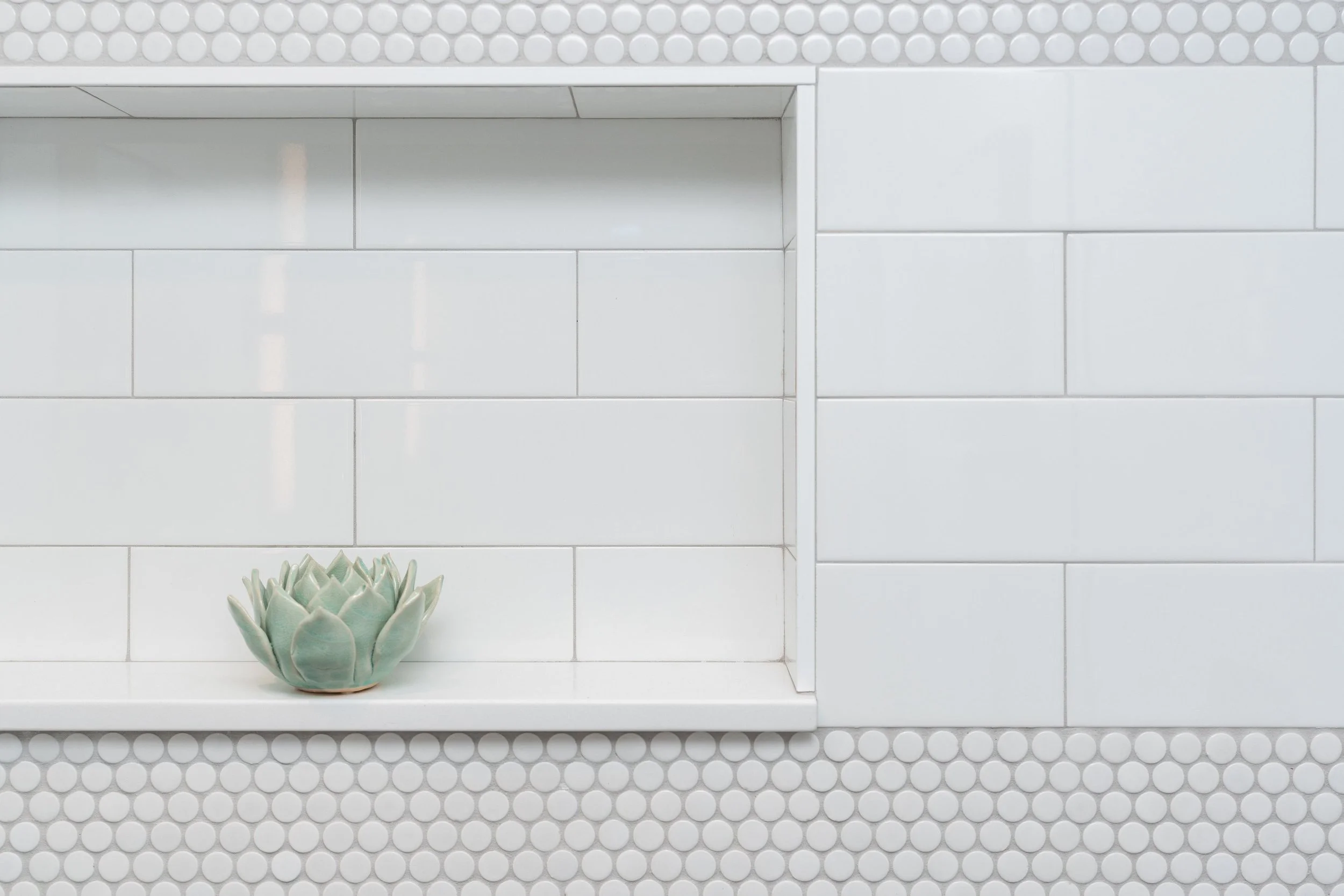 Shower niche w penny round horizontal accents band and taupe grout; Offset by offset subway tile