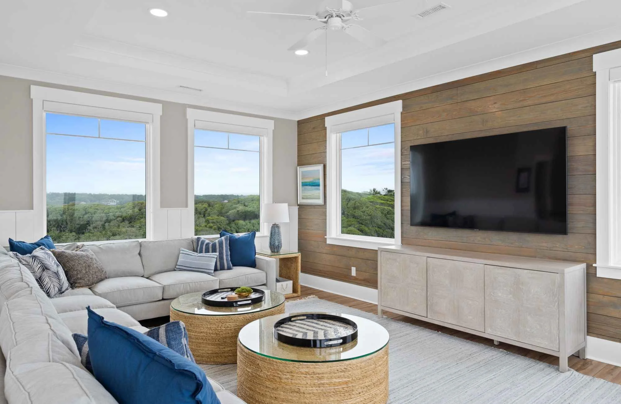 Coastal home interior with mixed wood tones and layered neutral furnishings
