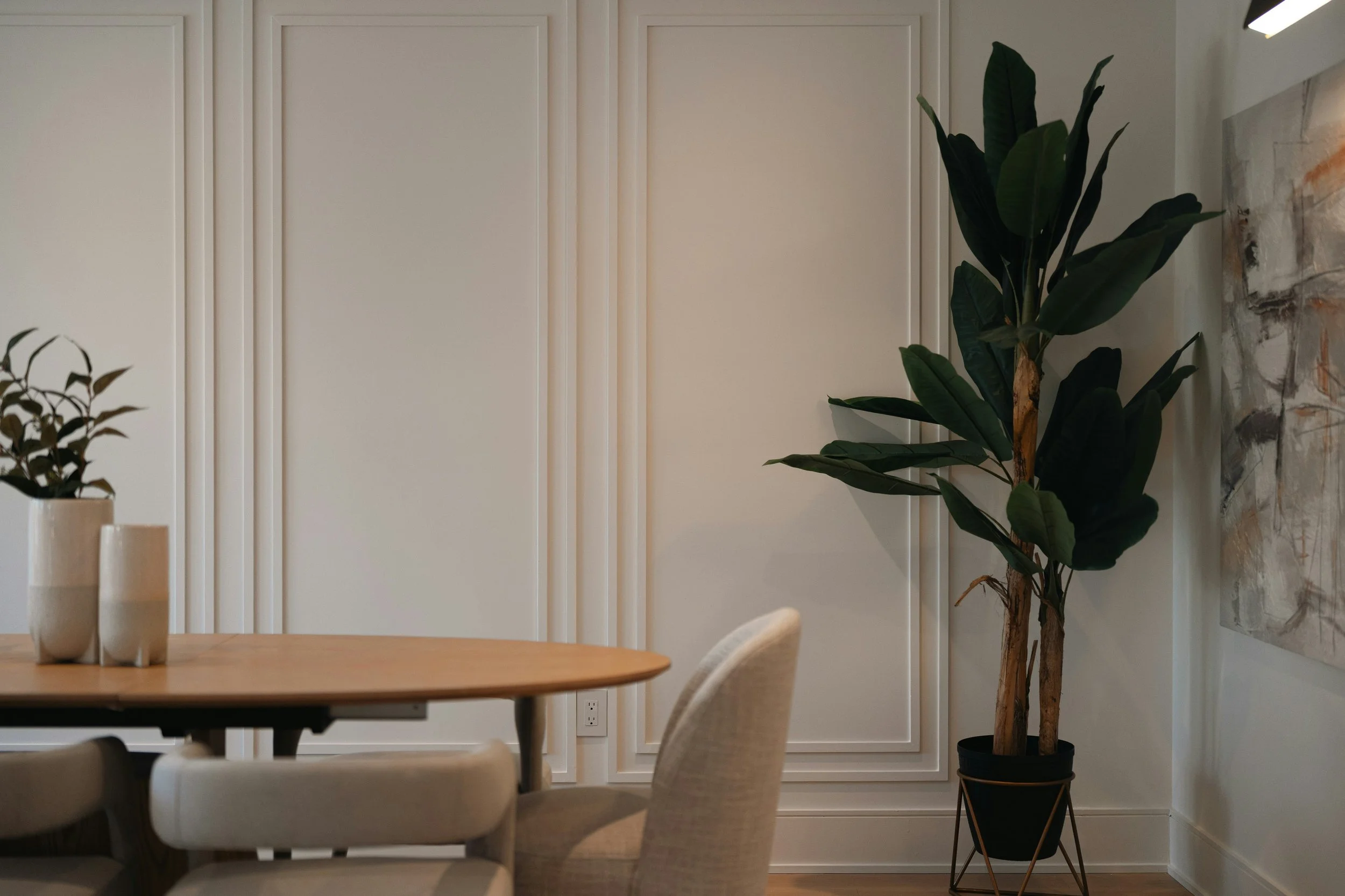 Decorative trim wall paneling in neutral dining room