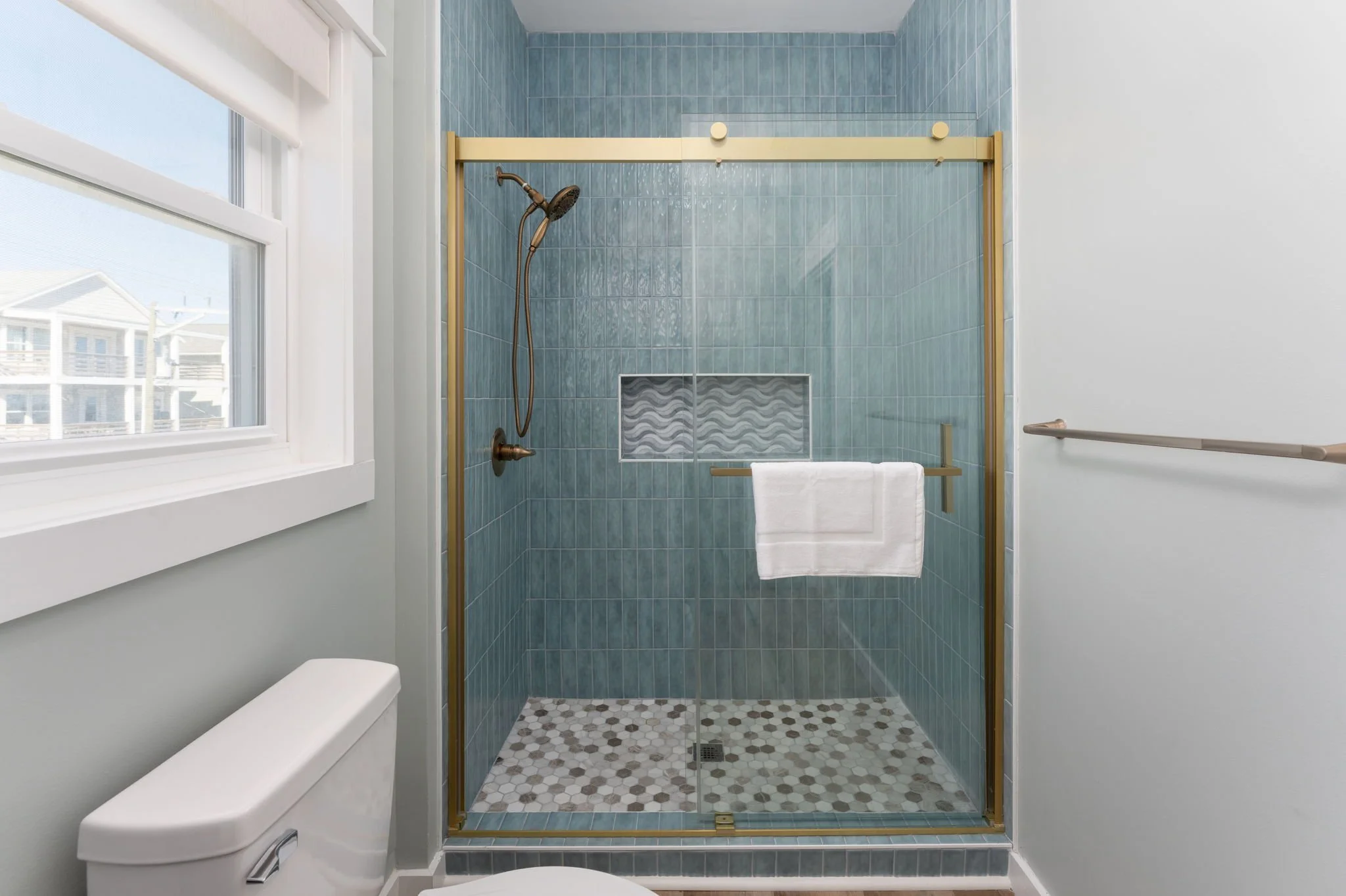 str-design-light-blue-stacked-tile-shower-gold-shower-door-wave-tile-niche.jpg