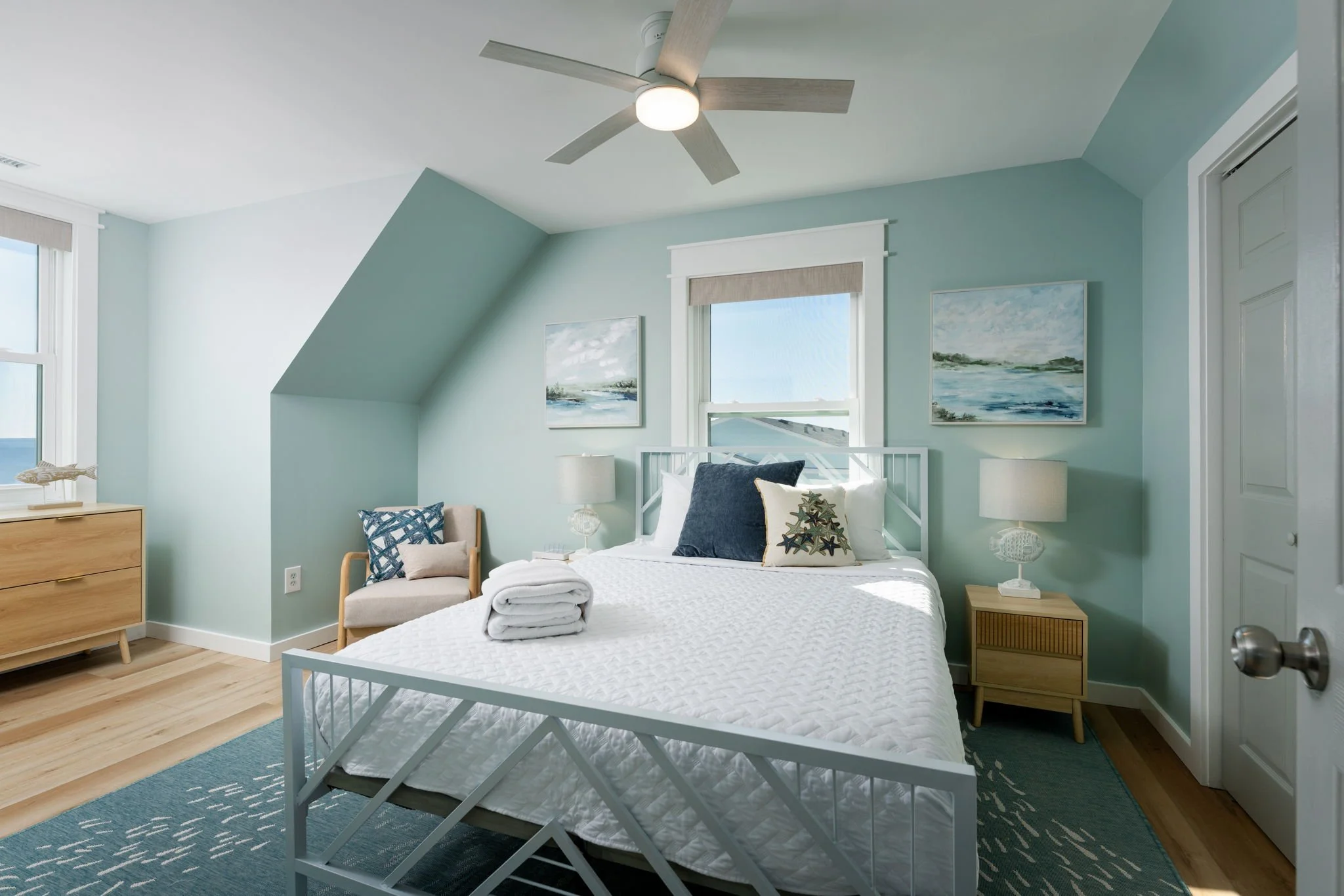 coastal-bedroom-design-short-term-rental-teal-fish-rug.jpg