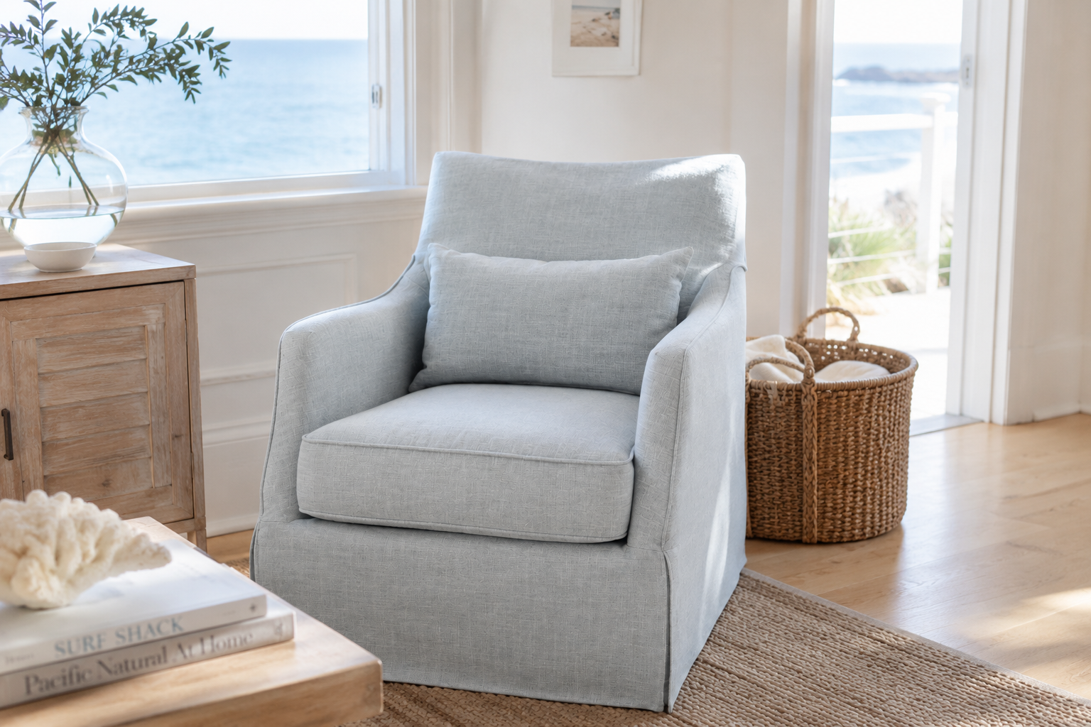 light blue swivel chair in Coastal living room with serene views