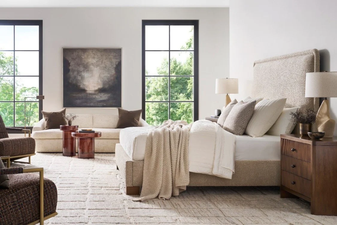 Fluffy hotel style bed with a quilt and plush throw