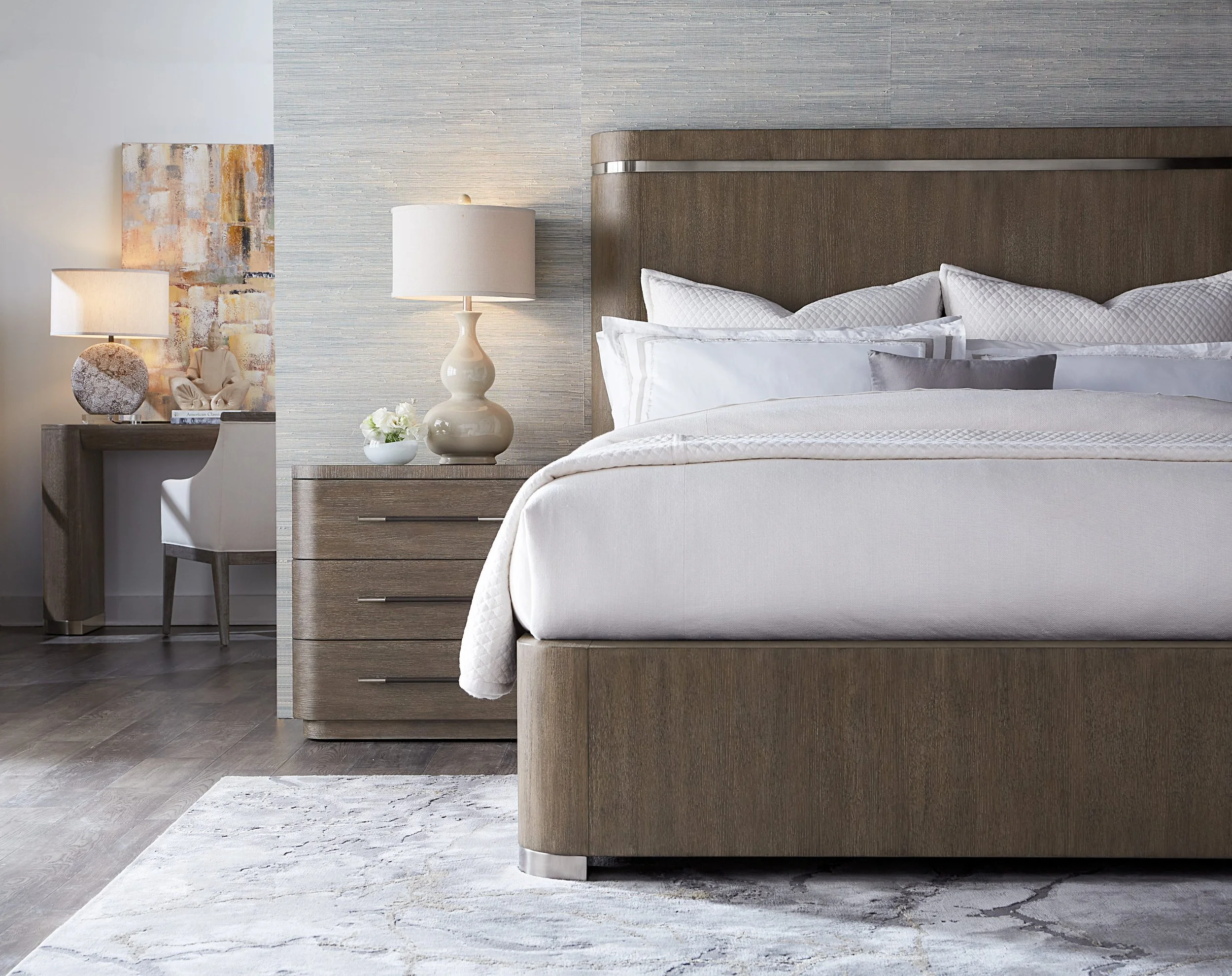Contemporary bedroom featuring a wood platform bed, neutral bedding, textured wallcovering, modern nightstands, and layered soft gray tones.