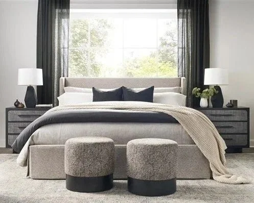 Designer bed styling with decorative pillows and neutral bedding