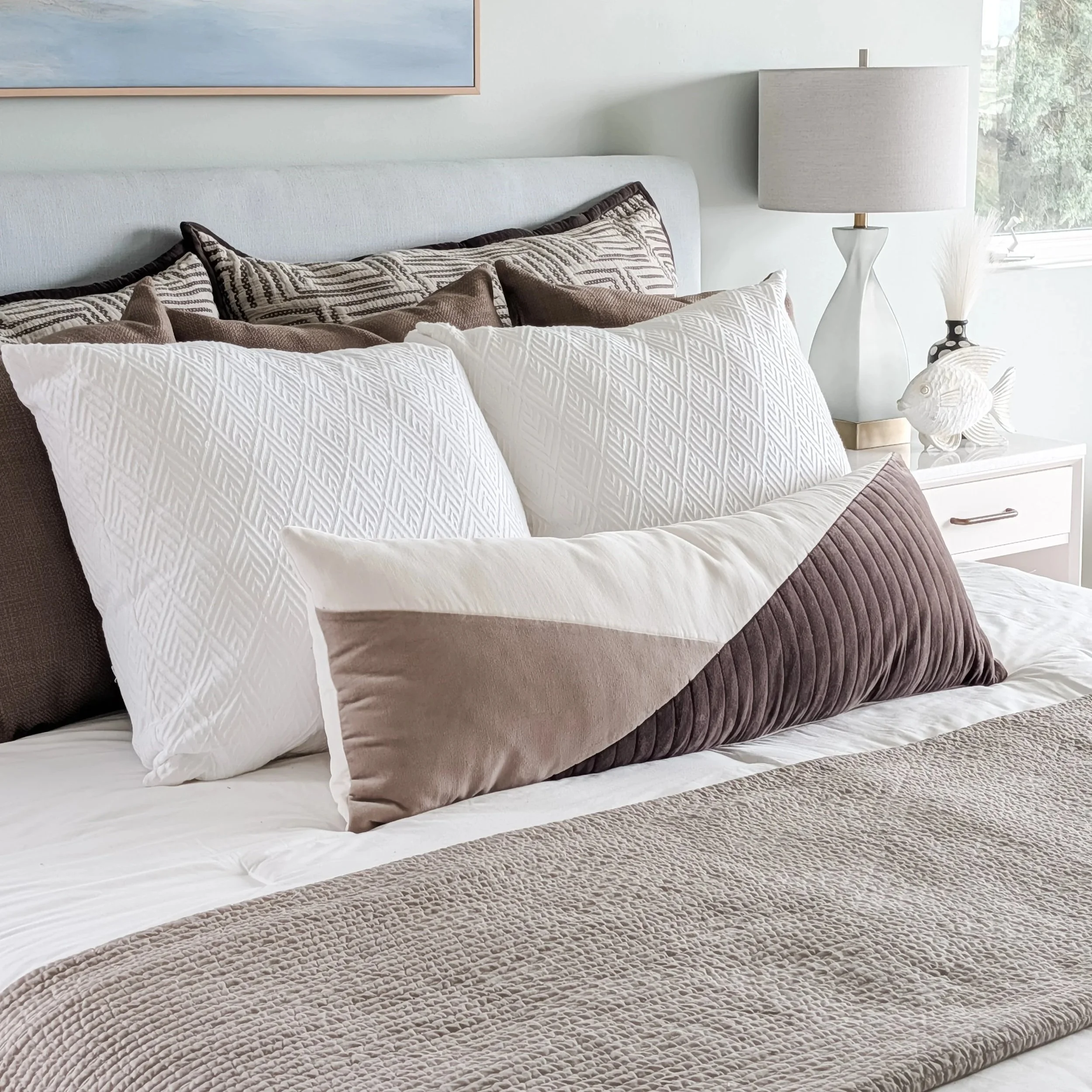 designer styled throw pillows on bed