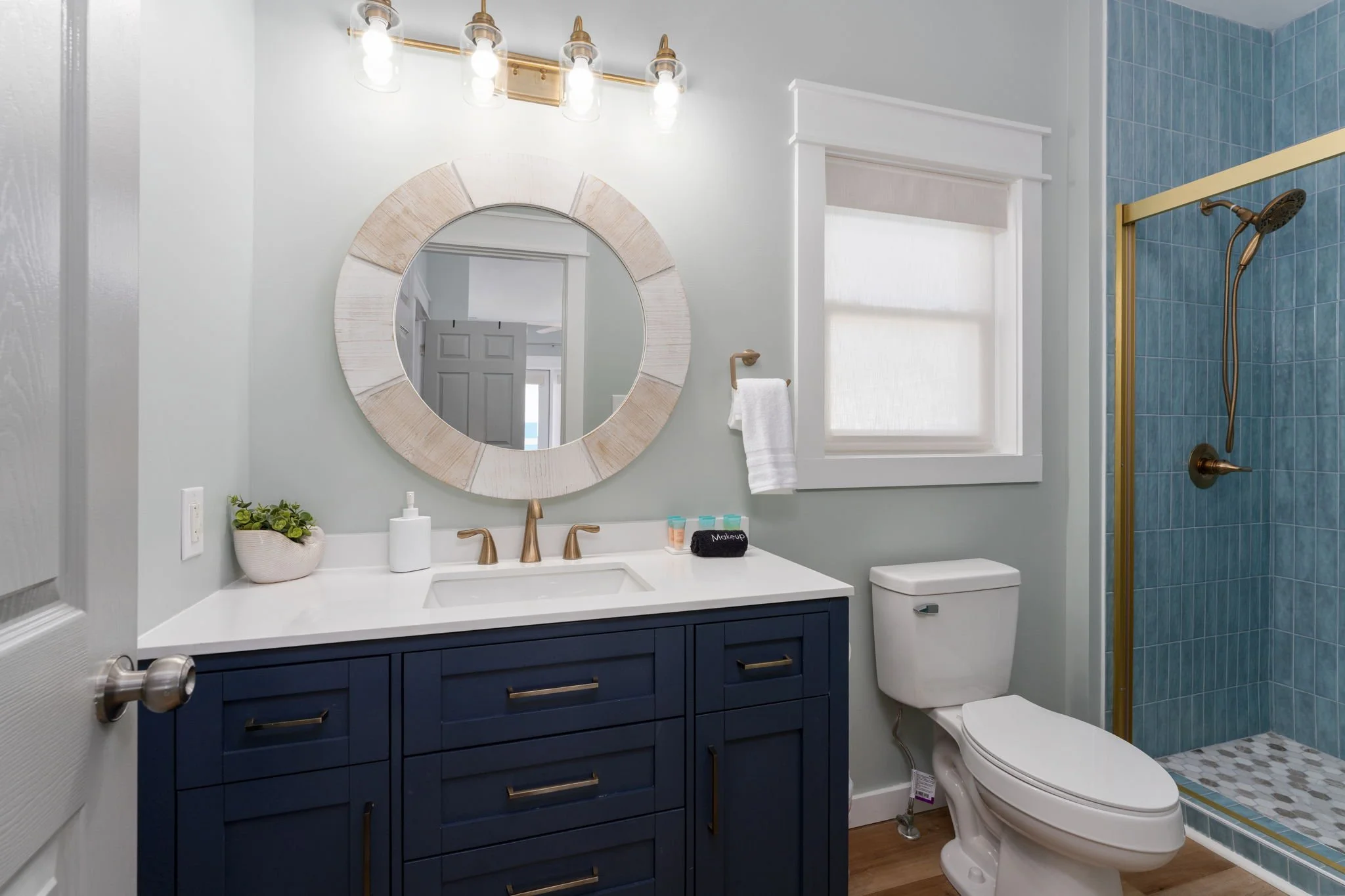 short-term-rental-design-coastal-bathroom-navy-gold.jpg