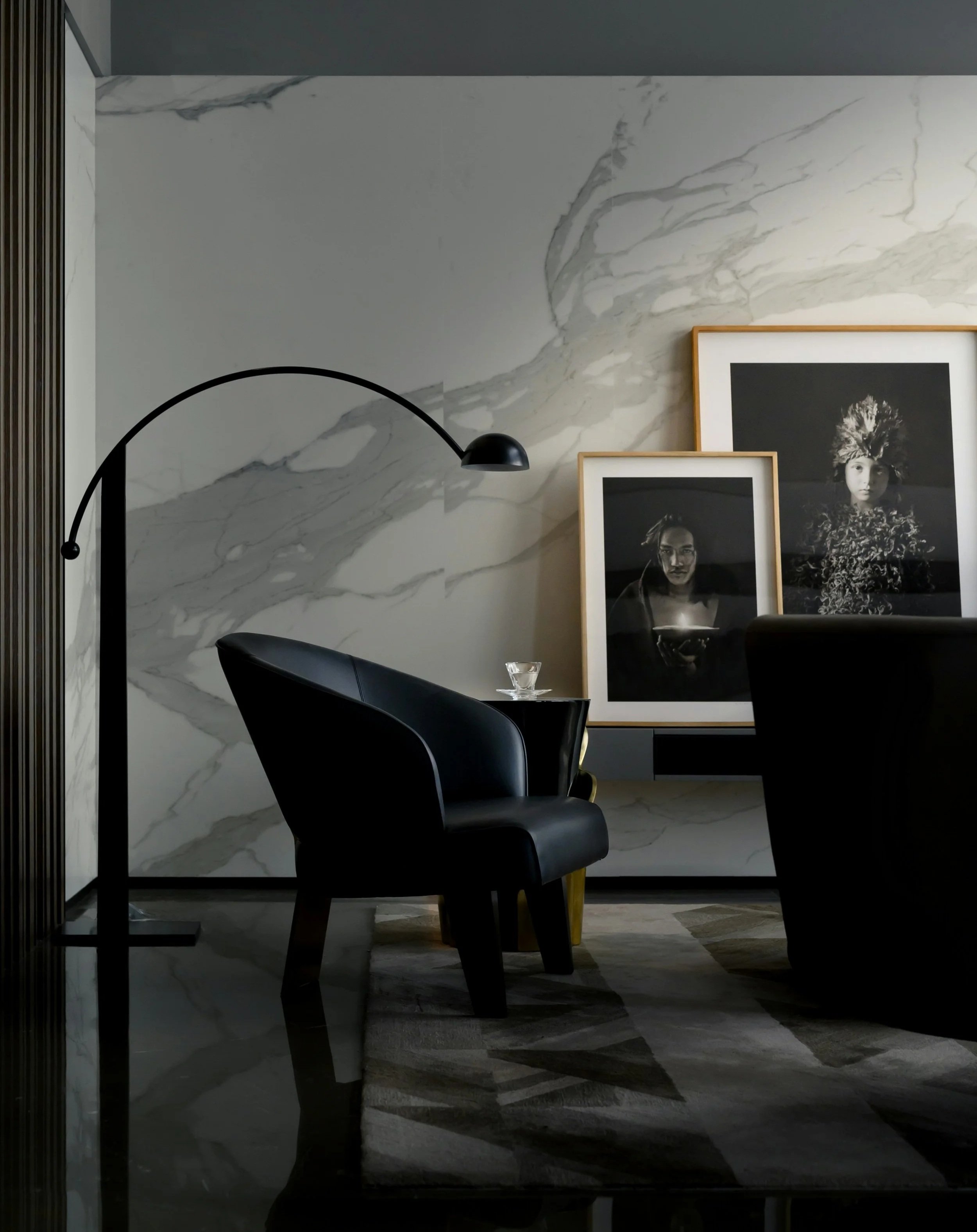 Marble slab accent wall with prominent veining in living room.