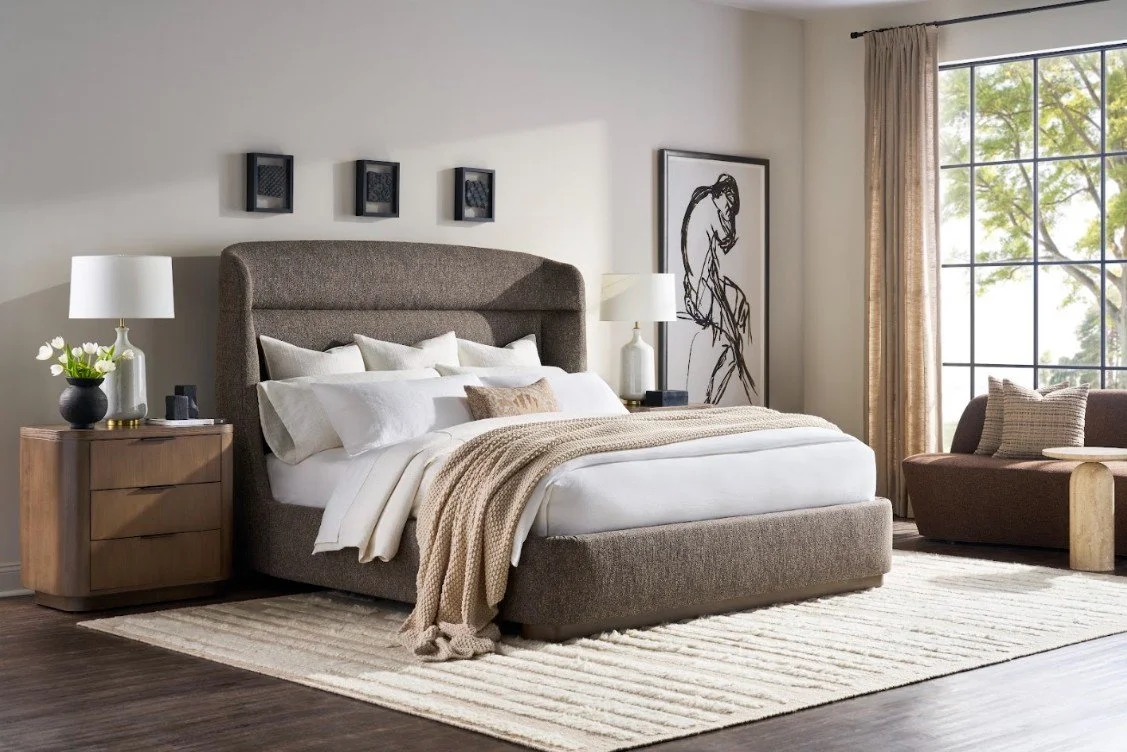 Luxuriously layered king bed with neutral pillows, oversized duvet, and soft throw