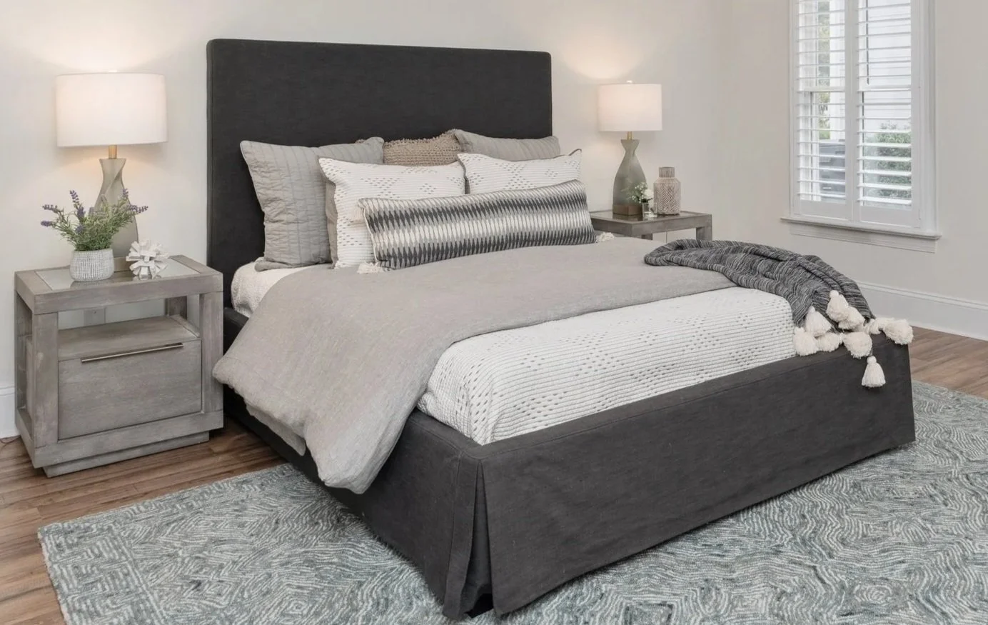 Neutral bed with soft patterns and hotel inspired layers