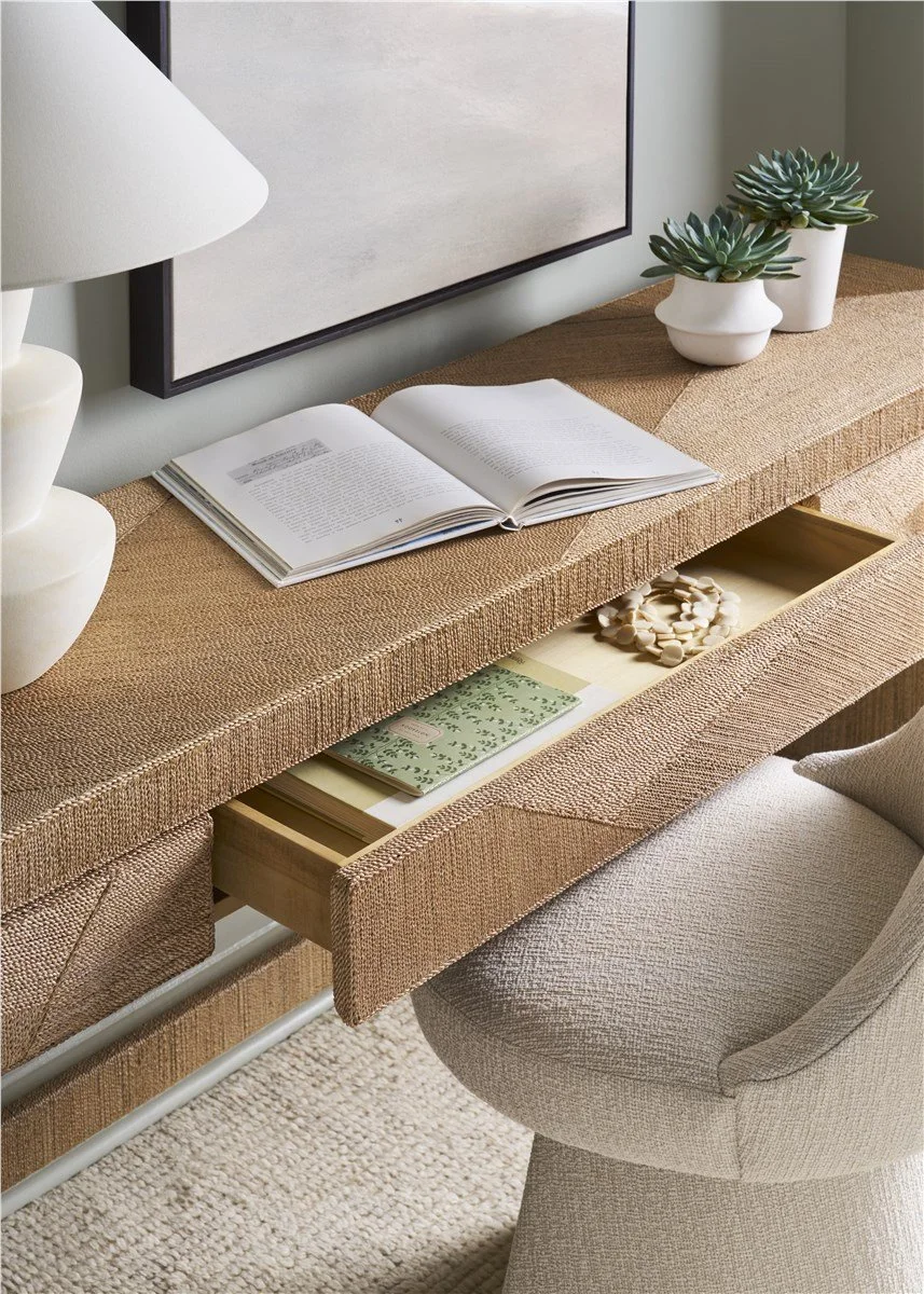 Modern coastal home office with sea-glass green walls and woven desk