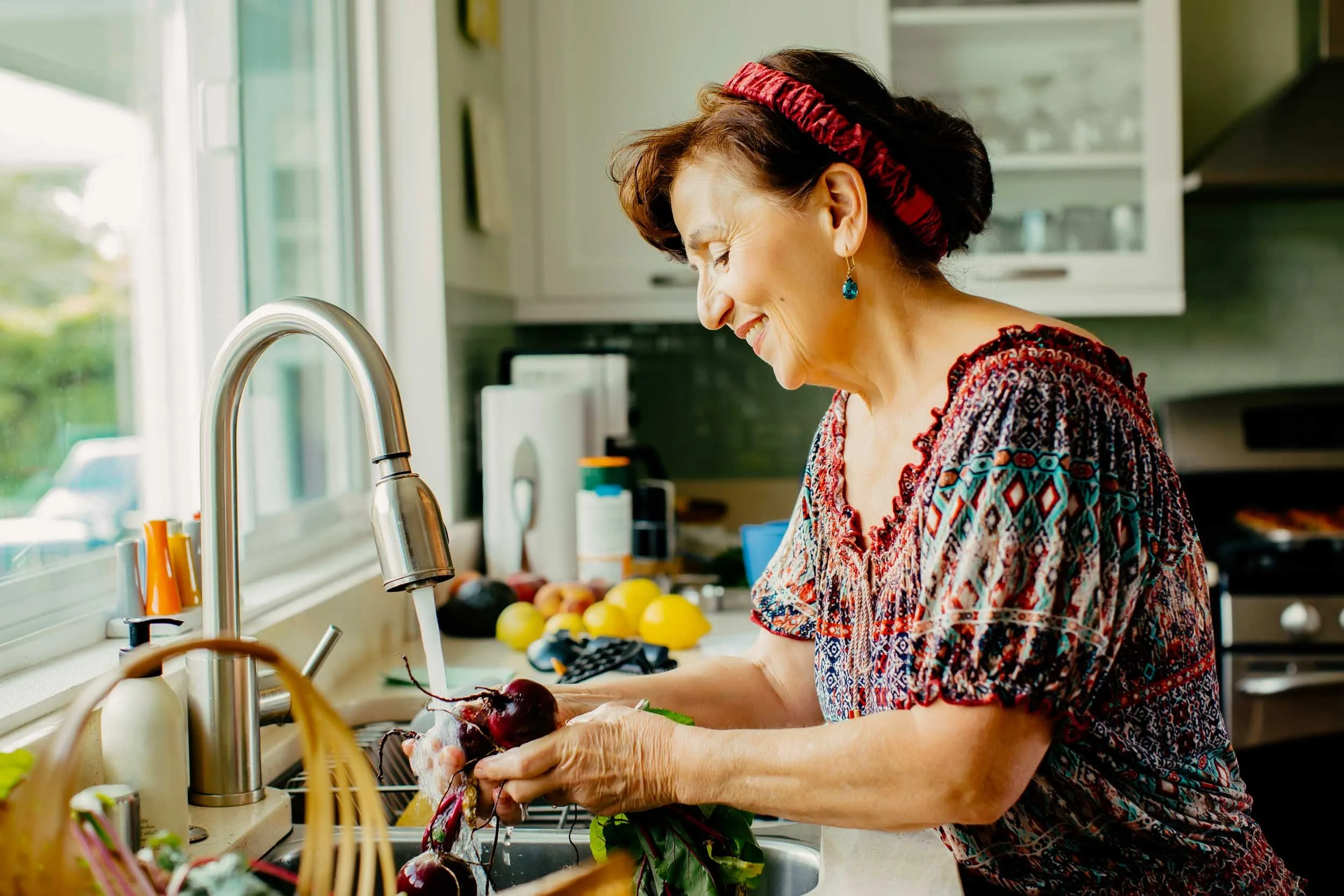 Woman-Washing-Vegetables-in-Kitchen.jpg