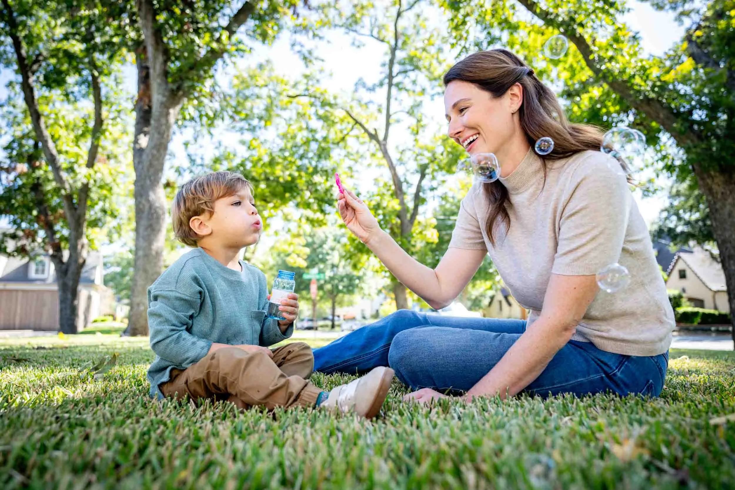 Woman-and-Child-Blowing-Bubbles-in-Park.jpg