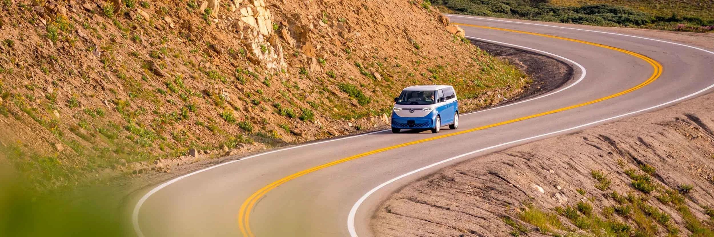 Blue-Volkswagon-ID-Buzz-Van-on-Winding-Mountain-Road.jpg