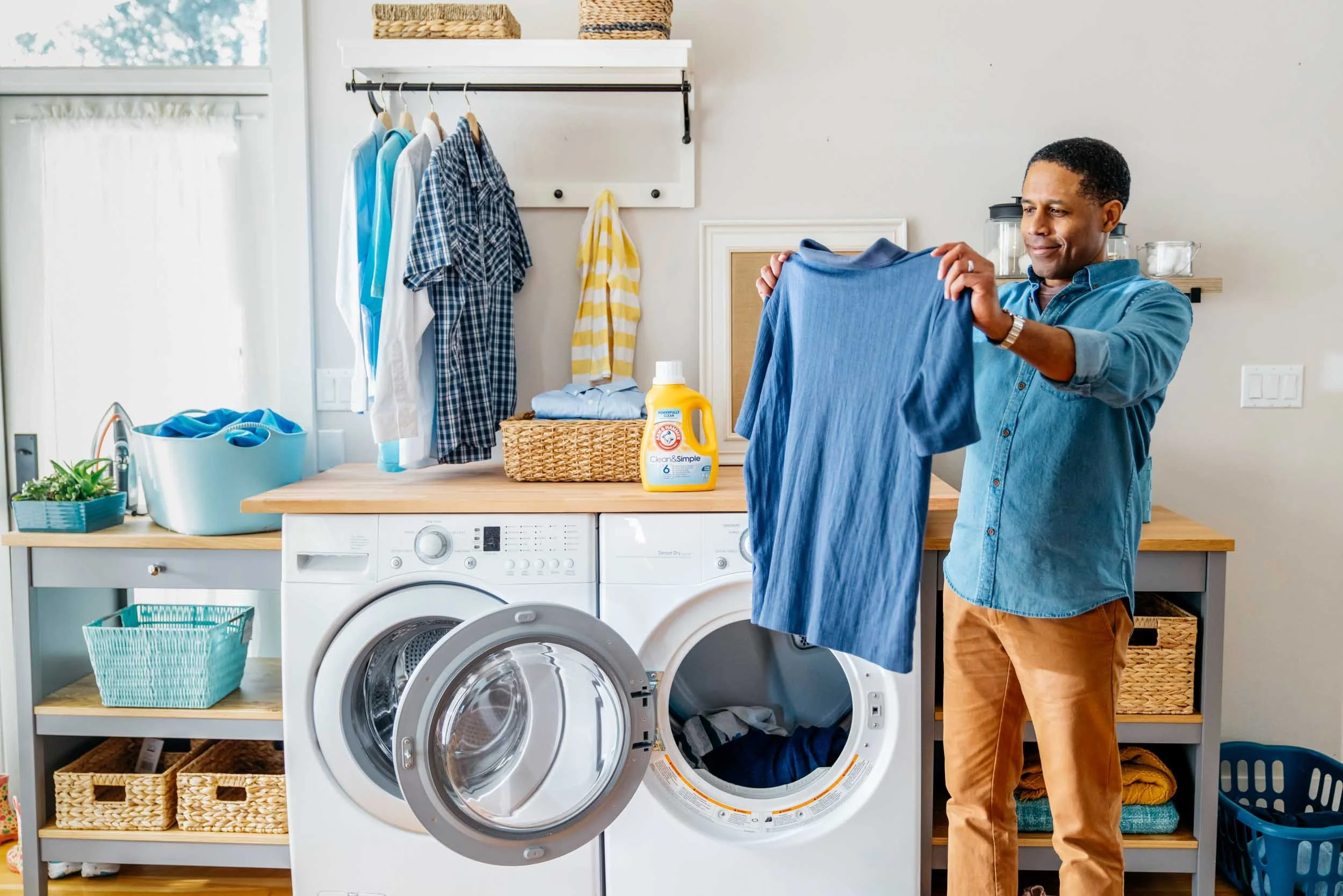 Man-holding-up-freshly-washed-shirt.jpg
