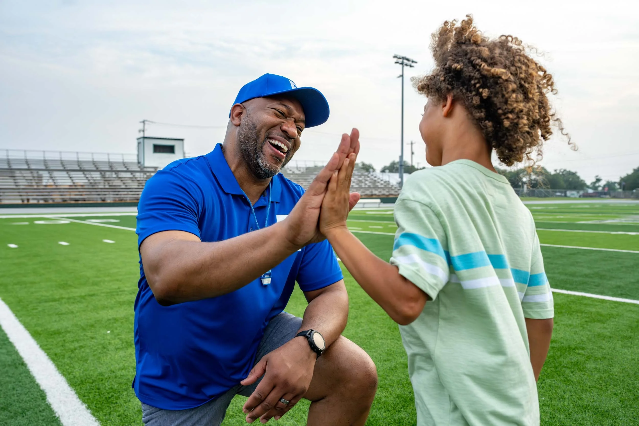 Coach-High-fives-Kid-on-Sports-Field.jpg