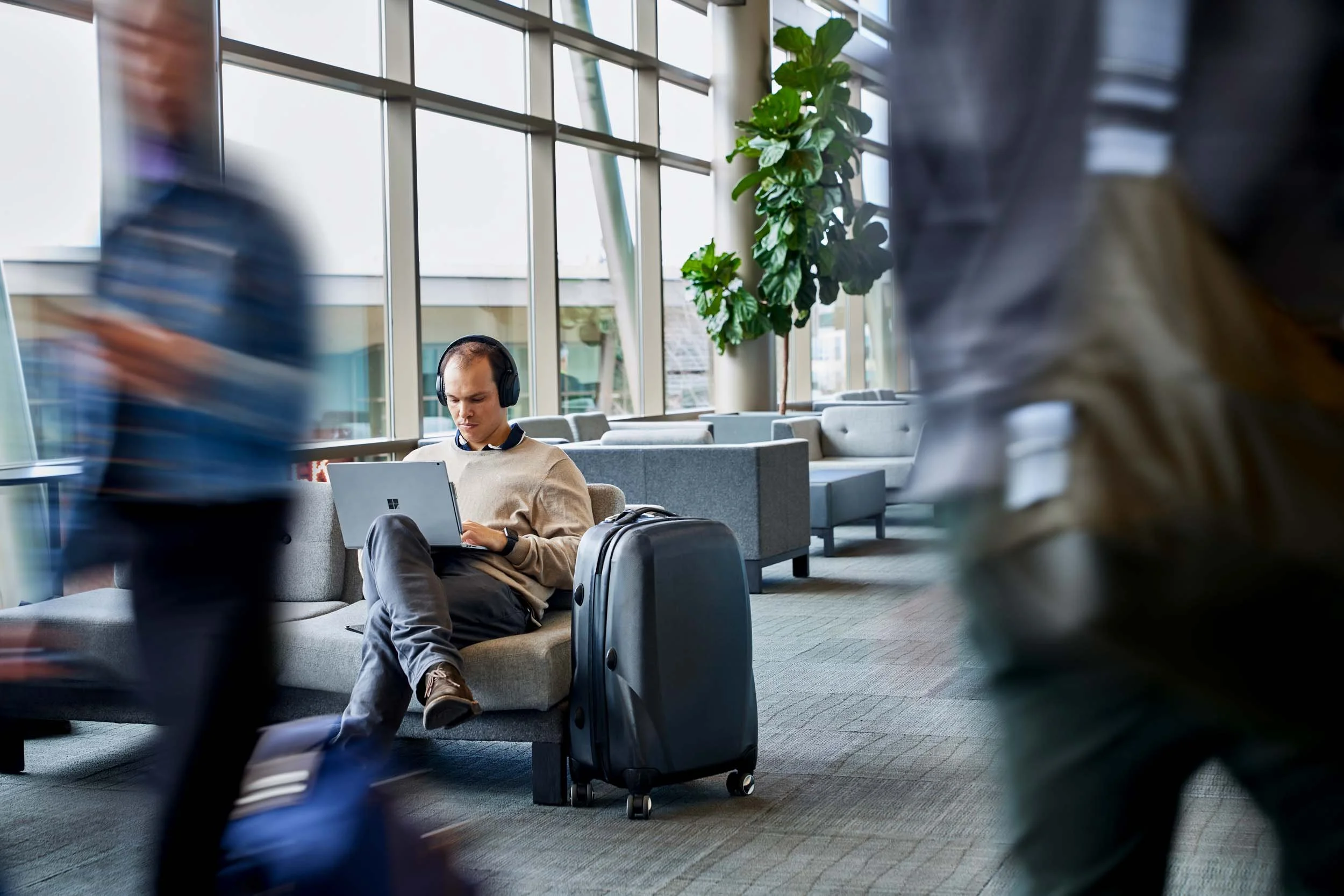 Man-Working-on-Laptop-in-Busy-Airport.jpg