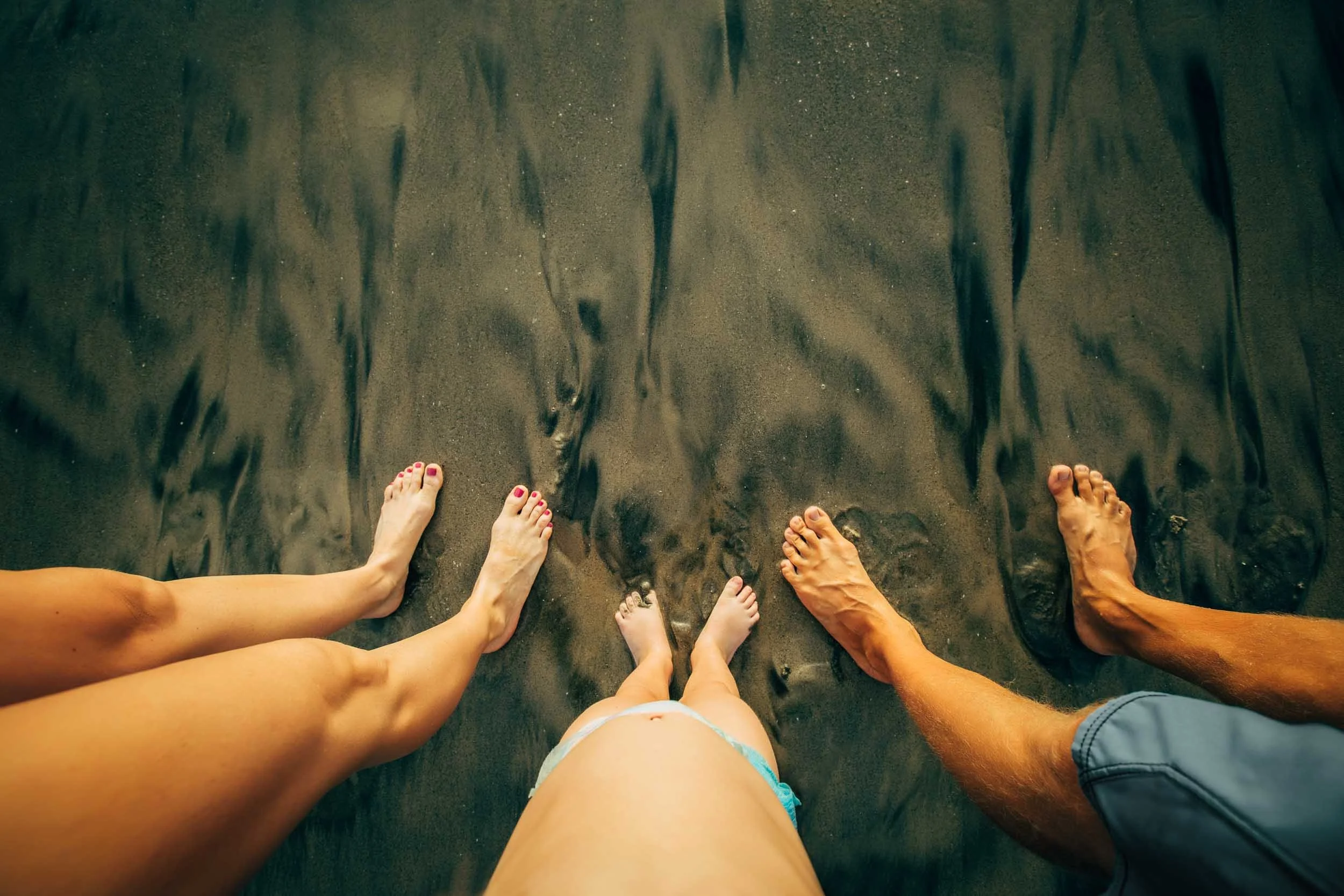 POV-familys-feet-in-sand.jpg